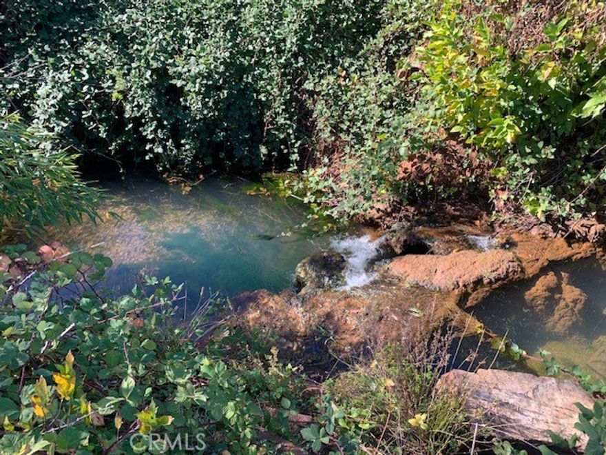 Creek front property with a working septic system. Original house was two bedrooms. This lot is tucked back off a main road allowing easy access to all stores, schools, restaurants and post office. Year-round creek and if you close enough, you might see the fish. Septic inspection is in supplements. PID water is current.