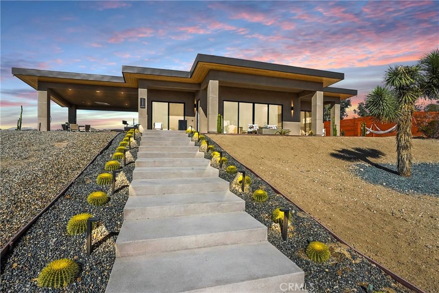 Welcome to 59080 Nelson Avenue — a newly constructed 2-bedroom, 2-bath modern desert retreat built in 2023, perfectly positioned in the sought-after Yucca Mesa neighborhood, just minutes from Joshua Tree National Park, Pioneertown, and downtown Yucca Valley’s shops and restaurants. This exceptional home seamlessly blends sophisticated design, smart technology, and serene desert surroundings for the ultimate indoor-outdoor lifestyle. The property is equipped with solar panels, providing energy efficiency and sustainability year-round. Currently operating as a highly successful Airbnb with numerous positive reviews, the home offers both investment potential and luxurious livability. Enter through the automatic gate into a fully enclosed property surrounded by a 10-foot wood privacy fence and lush, drought-tolerant landscaping with Bluetooth-controlled irrigation. Outdoor spaces were designed for relaxation and entertainment, featuring a custom deck, cowboy pool with lighting, Plunge cold plunge, jacuzzi, Clearlight UV sauna, gas fire pit, and RH fountain. Enjoy music through the outdoor SONOS speakers or unwind in one of the hammocks while taking in panoramic desert views. Every detail has been thoughtfully curated to create a seamless blend of comfort, privacy, and luxury. Whether as a full-time residence, weekend escape, or high-performing short-term rental, 59080 Nelson Avenue captures the essence of elevated desert living — where tranquility meets modern design, just moments from Joshua Tree.