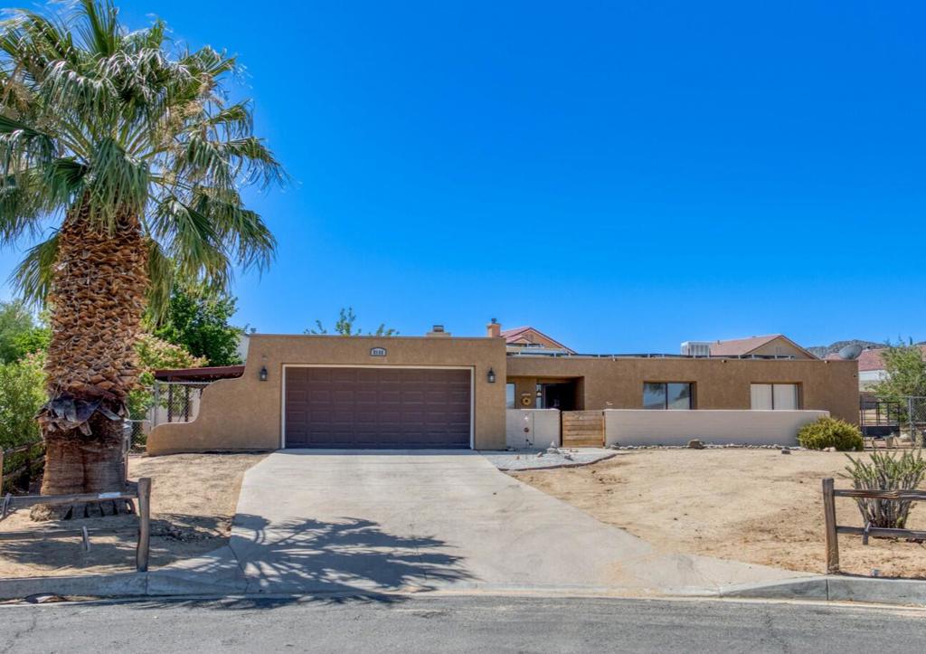 3 bed, 2 bath single level Spanish style home sitting at the end of a cul-de-sac street with 2,081 sqft of living space and a 15,675 sqft lot is ready for its new owner! The interior is spacious and open with recessed lights and a bonus room/enclosed patio. The living room features a stacked stone fireplace and flows into the dining area which sits just off of the kitchen with white cabinetry and stainless steel appliances. All of the bedrooms are generously sized, and the large primary bedroom offers a private slider to the backyard plus an updated ensuite with dual sink vanity, black subway tile backsplash and a walk-in shower. There is also a full-size hall bathroom for the 2 secondary bedrooms and guests to share. Enjoy the fully-fenced backyard with mountain and desert views, there is also a covered patio to enjoy. This home also features an enclosed front courtyard area, an attached 2-car garage, and plenty of driveway parking. Schedule your private tour today!