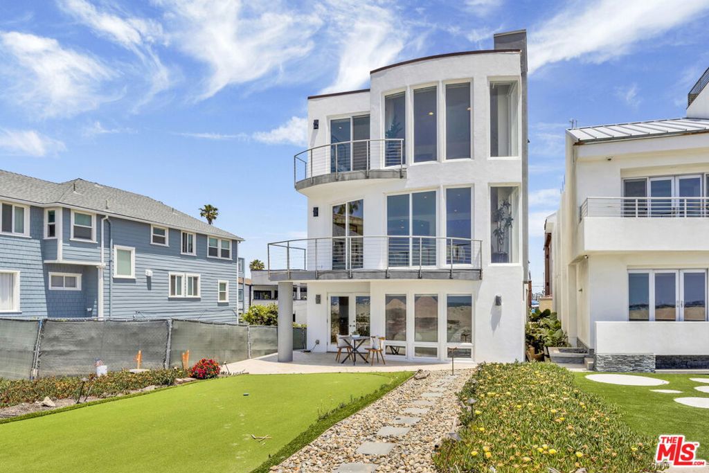 Welcome to this exquisite beachfront estate located at the prestigious tip of Long Beach Peninsula. This contemporary masterpiece offers breathtaking panoramic views of the Pacific Ocean, Alamitos Bay, and Catalina Island, delivering unparalleled coastal elegance. Boasting approximately 4,876 square feet, this sophisticated residence includes 4 spacious bedrooms and 5 luxurious bathrooms. Inside, high ceilings and recessed lighting enhance the home's inviting ambiance, complemented by three charming fireplaces. The grand primary suite is a serene retreat featuring an opulent ensuite bath with double sinks, a generous walk-in closet, fireplace, and captivating ocean views. A private guest suite provides independent living with its own kitchen, living area, bedroom, bathroom, and balcony. he gourmet kitchen impresses with extensive cabinetry, stainless steel appliances including a dishwasher, stove, range hood, and refrigerator and stunning ocean vistas. Expansive balconies and decks offer delightful spaces for entertaining or relaxing. A separate kitchenette further enhances the home's hosting capabilities. Additional highlights include a beach-level entertainment area with direct sand access, private wine room, fitness studio, two laundry rooms, and an elevator servicing all floors. Parking is effortlessly accommodated in the three separate-car garages. Perfectly positioned directly on the sand, this exceptional property epitomizes luxurious coastal living in one of Southern California's most coveted beachfront locations.