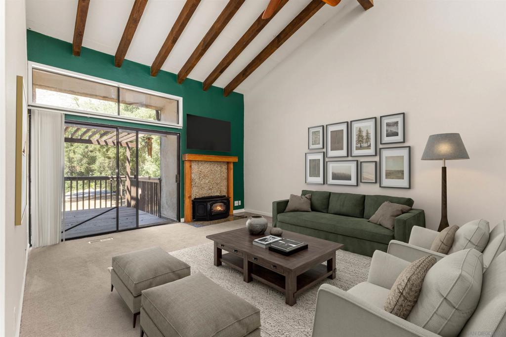 USDA home loan available with a low down payment. Welcome to the largest and best-priced floor plan in the coveted Tennis Villas at San Diego Country Estates! This spacious 3-bedroom, 2.5-bath condo stands out not only for its size and upgrades, but also for its unbeatable value. Tucked away in a peaceful, oak-lined corner of the community, this beautifully remodeled home blends contemporary finishes with serene mountain views. Inside, you’ll find engineered hardwood flooring, travertine tile bathrooms, and dramatic open beam ceilings that add charm and character. The kitchen and all three bathrooms have been thoughtfully updated with granite countertops, modern cabinetry, and sleek hardware. Additional custom touches include upgraded interior doors, baseboards, mirrored closet doors upstairs, and ceiling fans in every bedroom. Enjoy cool evenings by the cozy fireplace insert or take in the scenery from two private redwood decks, including one overlooking the park—perfect for morning coffee or sunset gatherings. Convenience is key with a short, level path to a spacious two-car garage, plus extra guest parking nearby. Located steps from the San Vicente Racquet Club and within walking distance to the SDCE pool and the private Tennis Villas pool, this home offers true resort-style living with easy access to shopping, dining, and top-rated schools. Don’t miss this rare opportunity to own the best-priced, largest unit in the community—schedule your private tour today!