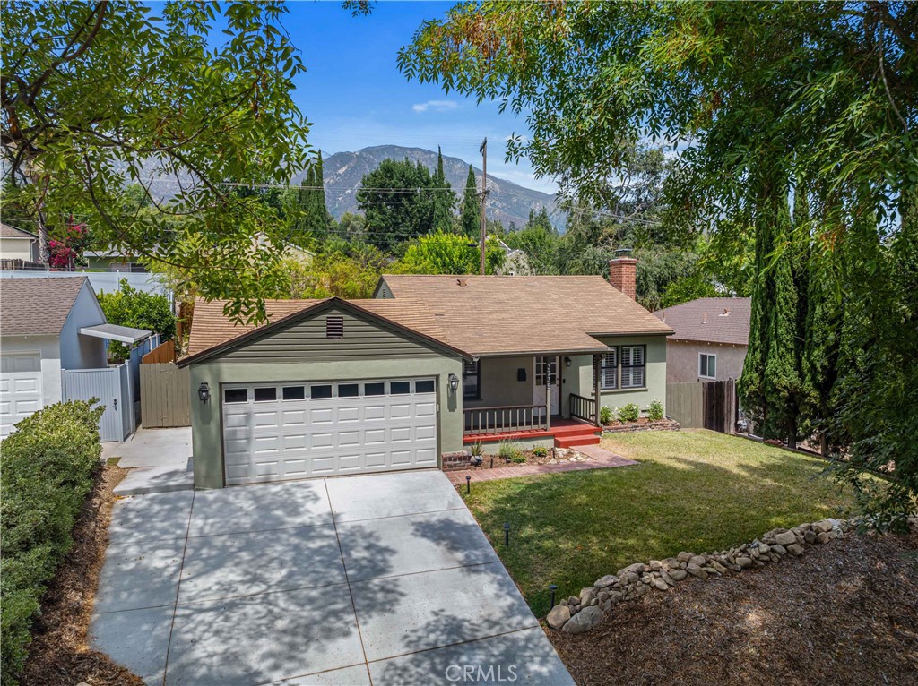Welcome to 3735 Danny Street, tree-lined & nestled in the desirable La Crescenta Highlands—an ideal retreat for nature lovers, offering scenic views of the Verdugo Mountains. Walking distance to Dunsmore Elementary and beautiful Dunsmore Park & a 3 minute drive to Crescenta Valley Community Regional Park. This charming home blends character, comfort, and convenience. Featuring 2 bedrooms, 1 full bath, and a versatile den (tax records show 3 bedrooms)—the den could be converted back to a bedroom. This home offers flexibility to suit your needs. A welcoming front porch greets you, and a freshly painted exterior enhances the home's curb appeal. Step inside to the living room with a classic brick fireplace and raised hearth, and windows with plantation shutters. Red oak floors run throughout the main living areas, while the kitchen and bathroom are finished with tile. The remodeled full bath offers a tub/shower combo with mosaic tile walls and a jetted tub. The upgraded kitchen, with beadboard accents and an overhead display shelf, is equipped with a 5-burner gas range, stainless steel sink, and a premium refrigerator by Cafe—all overlooking the spacious backyard and patio, perfect for outdoor entertaining or relaxing in the California sun. The 2-car attached garage includes a newer automatic roll-up door, with plenty of room for overhead storage and the 2-year-old concrete driveway adds both style and function. Additional features include: Abundant natural light throughout, central air and heat, smooth ceilings throughout, dual-pane windows, a tankless water heater, interior water supply is predominantly copper, where visible. Convenient location to walk to restaurants and shops! Short car ride to Crescenta Valley Regional Park which has a dog park, skateboard park, hiking trails, picnic areas, etc!! Walking distance to Dunsmore Park with a baseball diamond, tennis court, wading pool, walking trails, etc.!! La Crescenta has something for everyone!!