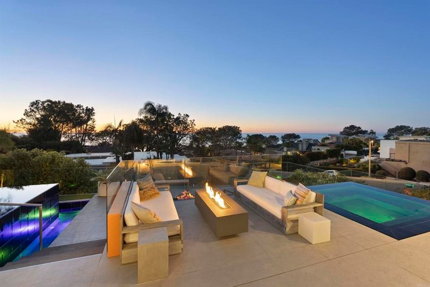 Welcome to 13675 Pine Needles Drive, a newly reimagined and masterfully rebuilt luxury residence in the heart of Del Mar, California—one of Southern California’s most coveted coastal communities. Showcasing breathtaking panoramic ocean views, flawless indoor-outdoor flow, and designer finishes throughout, this showpiece 5BR/4.5BA property sets a new standard for Del Mar luxury real estate.  Every detail of this architectural gem has been thoughtfully curated, from the sleek Italian oak floors to the precision shadow-reveal drywall and Starfire glass showers. An abundance of natural light pours into the open-concept living spaces through expansive Fleetwood sliding and pocket doors, offering seamless transitions to the resort-style exterior.  The chef’s kitchen is a true focal point, featuring Sub-Zero, Miele, and Bosch appliances, custom cabinetry, quartz countertops, a striking cantilevered island, dual dishwashers, and a built-in coffee station—designed for both elevated entertaining and everyday living. A separate wine center completes the gourmet experience.  The luxurious primary suite is your private sanctuary, complete with an ocean-view deck, a spa-style bathroom with a soaking tub and oversized open shower, and a custom walk-in closet. A landscaped rooftop deck offers yet another vantage point to soak in sweeping ocean views and sunsets.  Perfect for guests or extended stays, the 555-square-foot guest house above the garage includes a full bath, Ipe wood sundeck, and Fleetwood glass doors that open to postcard-worthy vistas.  The outdoor living spaces are equally exceptional. The front yard has been transformed into a private oasis, boasting a vanishing-edge pool, spa, tiered decking, and dramatic fire features. In the rear courtyard, you'll find a built-in BBQ, overhead heaters, a water feature, and a custom 12-person dining table—ideal for alfresco entertaining.  Tech-savvy buyers will appreciate the fully integrated Savant smart home system, offering motorized shades, multi-zone audio, security cameras, and whole-house automation.  Just minutes from Del Mar’s world-renowned beaches, dining, shopping, and the Del Mar Racetrack, this home delivers the ultimate luxury coastal lifestyle in a rare and private setting.