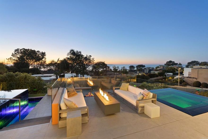 Welcome to 13675 Pine Needles Drive, a newly reimagined and masterfully rebuilt luxury residence in the heart of Del Mar, California—one of Southern California’s most coveted coastal communities. Showcasing breathtaking panoramic ocean views, flawless indoor-outdoor flow, and designer finishes throughout, this showpiece 4BR/4.5BA property sets a new standard for Del Mar luxury real estate.  Every detail of this architectural gem has been thoughtfully curated, from the sleek Italian oak floors to the precision shadow-reveal drywall and Starfire glass showers. An abundance of natural light pours into the open-concept living spaces through expansive Fleetwood sliding and pocket doors, offering seamless transitions to the resort-style exterior.  The chef’s kitchen is a true focal point, featuring Sub-Zero, Miele, and Bosch appliances, custom cabinetry, quartz countertops, a striking cantilevered island, dual dishwashers, and a built-in coffee station—designed for both elevated entertaining and everyday living. A separate wine center completes the gourmet experience.  The luxurious primary suite is your private sanctuary, complete with an ocean-view deck, a spa-style bathroom with a soaking tub and oversized open shower, and a custom walk-in closet. A landscaped rooftop deck offers yet another vantage point to soak in sweeping ocean views and sunsets.  Perfect for guests or extended stays, the 555-square-foot guest house above the garage includes a full bath, Ipe wood sundeck, and Fleetwood glass doors that open to postcard-worthy vistas.  The outdoor living spaces are equally exceptional. The front yard has been transformed into a private oasis, boasting a vanishing-edge pool, spa, tiered decking, and dramatic fire features. In the rear courtyard, you'll find a built-in BBQ, overhead heaters, a water feature, and a custom 12-person dining table—ideal for alfresco entertaining.  Tech-savvy buyers will appreciate the fully integrated Savant smart home system, offering motorized shades, multi-zone audio, security cameras, and whole-house automation.  Just minutes from Del Mar’s world-renowned beaches, dining, shopping, and the Del Mar Racetrack, this home delivers the ultimate luxury coastal lifestyle in a rare and private setting.  Offered exclusively by The Jason Barry Team at Barry Estates—Del Mar’s #1 Luxury Real Estate Team.