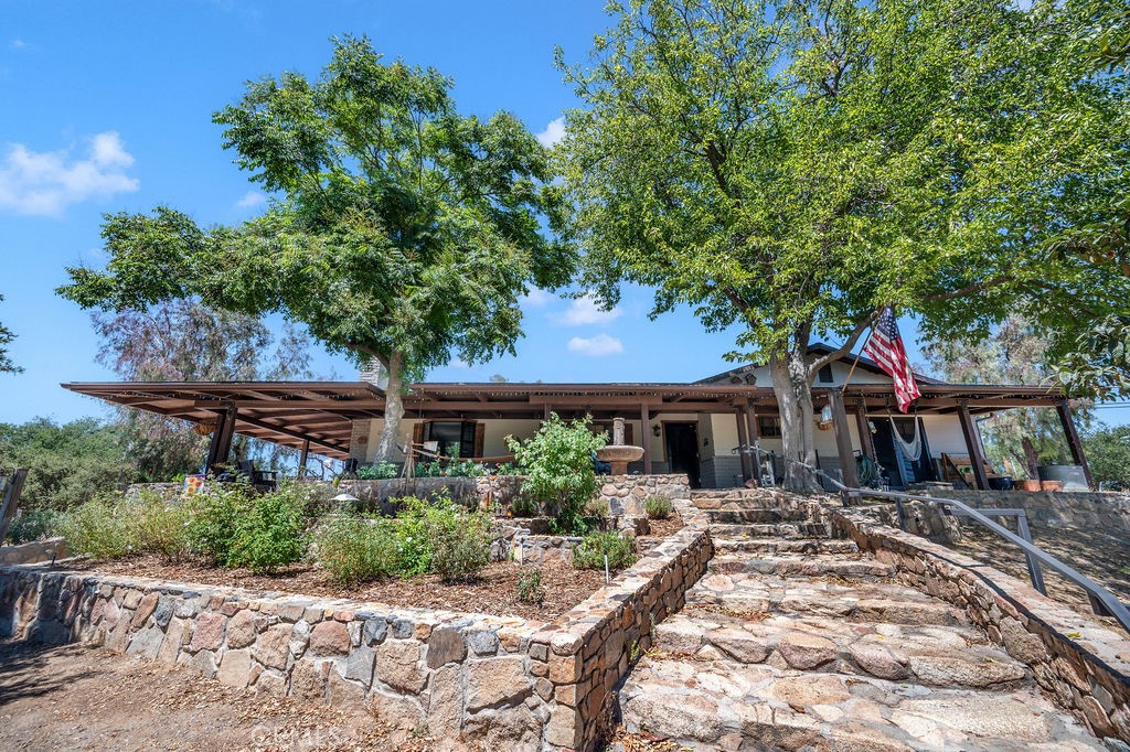 Live the Dream on 2.75 Acres in Rancho Capistrano!
This one-of-a-kind ranch property offers the perfect blend of rustic charm and modern convenience. Nestled in the serene gated community of Rancho Capistrano, this 3 bedroom, 2 bathroom ranch home boasts a spacious layout with a beautifully remodeled kitchen featuring open shelving, wood block counters, and upgraded appliances. Large great room with with fireplace is a perfect gathering spot and there is a huge mud/utility room adjacent to the kitchen. Enjoy the expansive wraparound porch, ideal for taking in stunning hill views and sunsets.
The barn has been completely updated including wash bays for the horses, new electrical, newer roof and updated flooring.
There is also a remodeled upstairs apartment/ADU with a kitchenette, spacious great room, and a stylish bathroom—complete with a separate septic system for added privacy.
Your horses are going to love their new home! 5 large pipe panel stalls, and a newer hay/garden shed and plenty of room to roam in both a front and back pasture.
Outside, enjoy ultimate relaxation with a 16ft swim spa, a covered pergola, and a variety of fruit trees along with a dedicated garden area. The property is fully fenced and cross-fenced, with an electric gate entry providing added security.
Additional features include an owned solar system and whole-house generator. Fantastic location with easy access to Temecula wineries and Orange County, just 30 minutes away.
This tranquil property offers a true country lifestyle with all the amenities you need for both leisure and luxury. Your dream home awaits!
