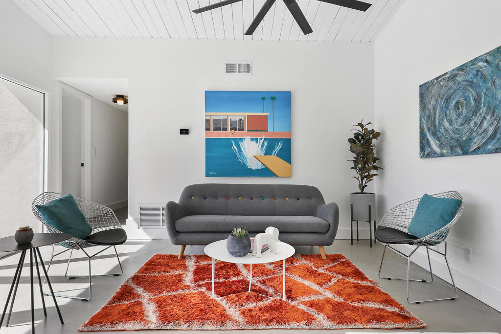 Welcome to Palo Fierro Estates, a 1966 mid-century modern gem that perfectly captures the vibrant, timeless Palm Springs lifestyle - on FEE land! This well thought out floor plan has two bedrooms and two bathrooms that are nicely separated by a beautiful private patio. Sliding doors on three sides create refreshing indoor/outdoor living, perfect for entertaining or simply allowing that fresh seasonal air in! A freestanding mid-mod fireplace steals the spotlight in the living area, surrounded by beamed ceilings and abundant natural light. The galley kitchen, with generous storage, has new counters and fully operational vintage ovens. The owner has also replaced all the windows and sliders, installed a new dishwasher, new washer and dryer, new interior doors, updated tile, faucets and mirrors in the bathrooms and more! With the updates, fresh paint and refinished concrete floors, this home is ready to come to life! Additionally, just steps outside the back door are two sparkling pools waiting for your enjoyment. This South Palm Springs neighborhood is moments away from golfing, hiking trails, shopping and dining...truly a special location that offers both tranquility and easy access to Palm Springs' vibrant scene! Welcome home!