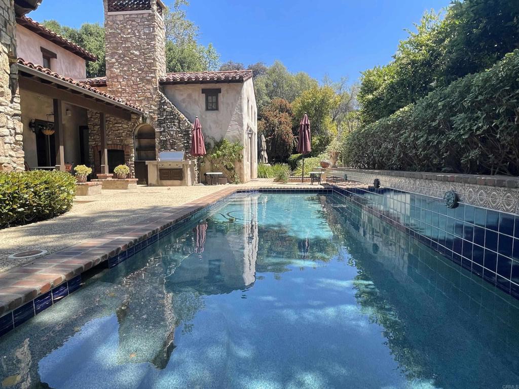 Tranquil and nestled in the exclusive golf course community of The Bridges at Rancho Santa Fe, this single level Italian Villa features 3 bed and 3.5 baths tucked away in a private cul-de-sac surrounded by lush landscaping and stunning mountainous views. The main home is tastefully renovated with two (2) spacious bedroom suites and two (2) additional rooms which could be used for office, library, flex space or another bedroom. A detached casita third (3rd) bedroom suite is perfect for guests and extended family. Unwind in the large main suite with high ceilings and an open renovated kitchen with breakfast bar! The covered loggia with fireplace overlooks a relaxing backyard with your own private pool and jacuzzi. Entertain your friends and family with the built in BBQ and generous side yard perfect for relaxing and entertaining! The home has a two (2) car garage and ample storage. This home is the perfect blend of luxury and comfort!