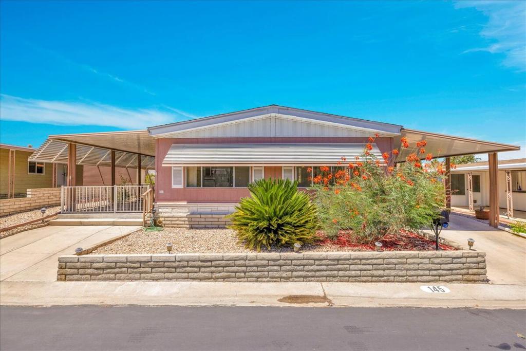 This vintage manufactured home in the wonderful 55+ Gates of Spain Mobile Estates is a fantastic opportunity! This 2 bedroom/2 bath home has wonderful vintage features and can be enjoyed as-is or bring your contractor and designer to raise this home to a new standard of living. With 1856 square feet of space, this is one of the larger homes in the park. Through your front door is a grand living room with brand-new floors and a built-in china cabinet. The groovy curved kitchen has lots of storage, spacious pantry and 5 burner cook top. The kitchen is open to a large family room with wet bar - perfect for entertaining. The primary bedroom has a walk-in closet and a slider to an enclosed patio. The primary bathroom has separate tub and shower and is filled with original vintage detail. The laundry room is big too, with more room for storage. The guest bedroom has been outfitted with rows of bookshelves - perfect for a voracious reader or collector! The front patio is spacious and bathed in light. Carport can easily fit two cars, and possibly three. An 8x12 shed with electricity can be a workshop or simply a great place to store seasonal decor or collectibles. Gates of Spain has a community club house with pool and an indoor spa/hot tub. Trash service is included in the space rent. Prospective buyers must apply for residency with the park manager. The space rent for the new owner may be different/higher than what is paid by the current owner. Come see it today!