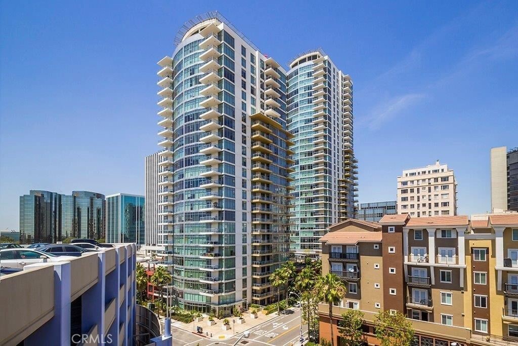 Call this modern luxury high-rise condominium home. This premium southeast facing corner unit is what you have been waiting for. This light and bright home has floor to ceiling windows bringing in natural light in the day and city lights at night. There is a large balcony that feels like extra living space. Perfect for entertaining, taking in the view or watching the New Years’ Eve fireworks off of the Queen Mary. This highly desired model have a tech-center space with upgraded built in cabinets that works perfectly as a home office. Both bedrooms have a wonderful view while retaining their private feel. Upgraded flooring in the living room and stainless steel appliances give it a richer feel. The convenience and comfort you would expect in a modern luxury high-rise, there is an in-unit washer and dryer, as well as central AC and heating system. THIS UNIT HAS AN ADDITIONAL STORAGE SPACE. Luxurious, Hotel-like Amenities Include Concierge, Multiple Fitness Centers, Pool/Spa Area, Billiard/Club Room, Lounge Areas, Library, Outdoor BBQ Area, Climate-Controlled Wine-Storage Area, and Guest Accommodations. The building includes Subterranean Parking for Two Vehicles. Walk to Entertainment, Restaurants, the Ocean, the Terrace Theater, Shoreline and the Pike.