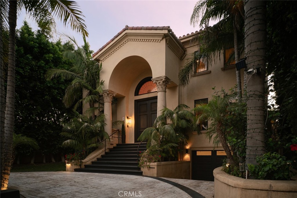 Set on nearly half an acre in Newport Beach’s coveted equestrian-zoned enclave, this 7,000+ sq. ft. custom Mediterranean estate masterfully blends timeless elegance with modern luxury. A grand entry with handcrafted double doors opens to a soaring foyer crowned by dual spiral staircases, an architectural centerpiece of the home. Formal living and dining rooms exude sophistication, while the expansive family room offers a wet bar, rear-projection cinema screen, and Crestron home automation. The chef’s kitchen features granite countertops, custom cabinetry, a butler’s pantry, and professional-grade appliances, all flowing seamlessly into the home’s gathering spaces. The primary suite is a private retreat with a fireplace, spa-like bath, steam shower, dry sauna, and custom walk-in wardrobe room. Two upstairs en-suites and two main-level guest suites provide luxurious accommodations. A private elevator serves all levels, including the rare subterranean seven-car garage with its own workshop. Outdoors, a resort-style pool and spa, full-size illuminated tennis court, and lush grounds create the ultimate entertainer’s paradise, all just minutes from Back Bay trails, renowned beaches, fine dining and shoping, offering an unmatched locale.