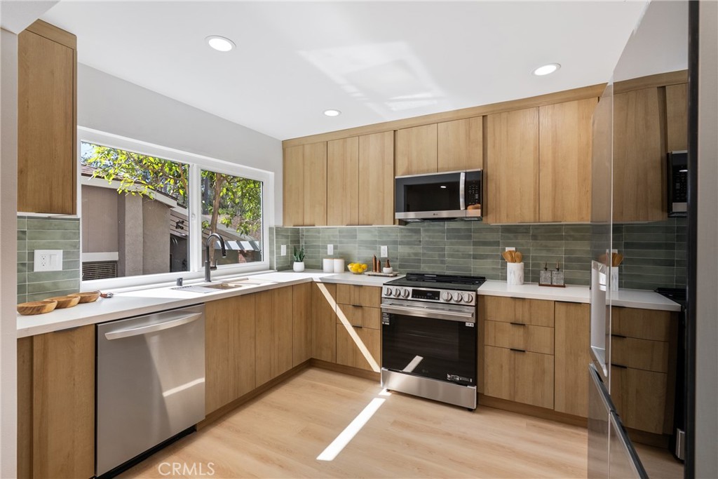 Welcome to 6577 Camino Vista #6, an impeccably remodeled two-story townhome offering 3 beds and 3 baths — where refined finishes meet everyday living. As you enter, dramatic ceilings and wraparound windows immediately frame light and sky in the living area, giving you that elevated, open-air luxury feel. The kitchen is your centerpiece: custom tile, rich oak paneling, and bespoke countertops. A picture window looks out to green surroundings, bringing in calm and privacy. Throughout, premium new flooring ties together the living room, dining, and all bedrooms in a clean, elegant flow. Slide open the glass doors in the dining space and step into your private patio, where hillside shade and views toward the golf course set the stage for quiet mornings or refined evenings outdoors. Upstairs, a generous loft space offers versatility — perfect for a high-end home office or a lounge where form and function coexist. The primary suite delivers retreat-level luxury: abundant closet space, a spa-style bathroom with freestanding tub, separate shower, and dual-sink vanity in striking black tones. Two additional bedrooms offer room for family or guests, and the two-car garage with dedicated laundry & storage keeps everything in order. You’ll enjoy the peace of a well-cared for neighborhood, just minutes from top-rated schools, hiking trails, golf, fine dining, shopping, and entertainment. The HOA takes care of pool access, roof, and common area maintenance — style and assurance without the work. This isn’t just a home — it’s a lifestyle upgrade. If you value elegance plus comfort in a community that feels both exclusive and inviting, this is the one.