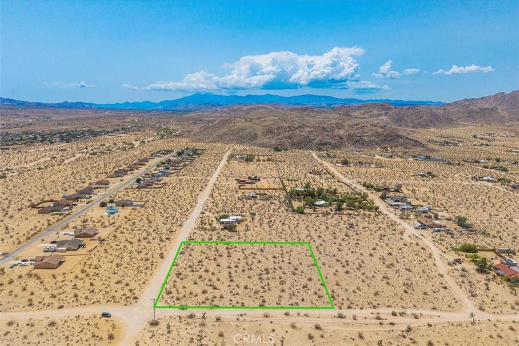 Looking for that perfect location to build a getaway, home or retirement retreat? This corner, 2.5 acre parcel offers plenty of room to enjoy the beauty and peace of desert life, and still be a few short minutes from the action in downtown Joshua Tree. Located in Old Town West, this buildable lot is just off a paved road in a rural yet residential area, with spacious lots and utilities adjacent (buyer to verify). Bring your plans and build a future as a 'local artist' on the Art Tours, hike Coyote Hole, or hike, climb and star-gaze in Joshua Tree National Park - there's always something new to explore just around the corner! Neighboring homes have recently sold for up to 820k.