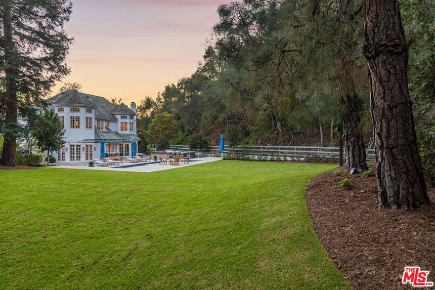 Newly renovated, move-in ready estate on one of the most secluded streets in Los Angeles. Set on 3.1 acres in lower Mandeville Canyon, this country English traditional is gated and landscaped for total privacy and absolute serenity. Custom-designed finishes and woodwork highlight an open yet intimate floor plan that exudes volume and scale in every room. The formal entrance is a stunning two-story foyer with black & white marble and limestone tile framed by a white oak, quarter-turn staircase with custom designed steel & brass handrails. The ground floor showcases a formal living room, 2 elegant powder rooms, dining room, family room with 4-seat bar, wood paneled office or media room, chef's kitchen with butler's pantry and breakfast room, and 2 en suite bedrooms. The second floor boasts an expansive and lavish owner's wing with separate bathrooms, separate boutique walk-in closets, and office or nursery, and 4 additional en suite bedrooms. 10 French doors open to a rolling front lawn and a sweeping back lawn with breathtaking canyon views. A blue-tiled 40-foot pool & spa and limestone barbecue & 8-seat bar complete an entertainer's paradise. Additional luxe features include Crestron smart home system, Lutron lighting, state-of-the-art security system, laundry rooms on both floors and a separate entrance for staff and service. This rare and countryside setting is only minutes from Brentwood, Santa Monica & Pacific Palisades. Additional photos and property website available upon request to qualified buyers and their agents.