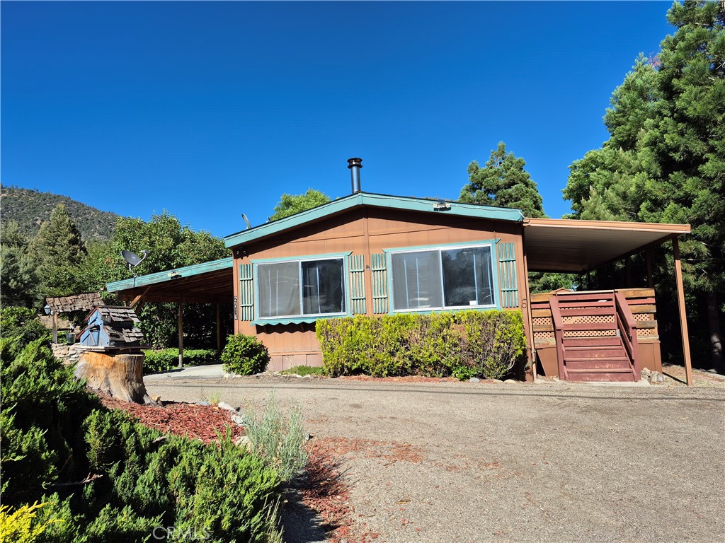 Charming 2-Bed, 2-Bath Single-Level Mountain Retreat with Deck, Carport, Wood-Burning Stove & Laundry Room.
Tucked away on a peaceful, sunlit street in the heart of the mountains, this 2-bedroom, 2-bath manufactured home offers the perfect blend of quiet living and potential. Designed for easy, single-level living, the home features a bright layout with natural light throughout and a strong foundation for personalization.
The spacious living room opens directly onto a private deck—ideal for relaxing outdoors or enjoying the fresh mountain air. Inside, you'll find an EPA-approved wood-burning stove for cozy evenings, and a dedicated laundry room with washer/dryer hookups for added convenience. A covered carport provides year-round shelter for your vehicle.
Please note: while the home is functional and well-maintained, the buyer will need to undertake cosmetic improvements to bring out its full charm and value. This is a great opportunity for those looking to customize their space or invest in a property with strong potential.