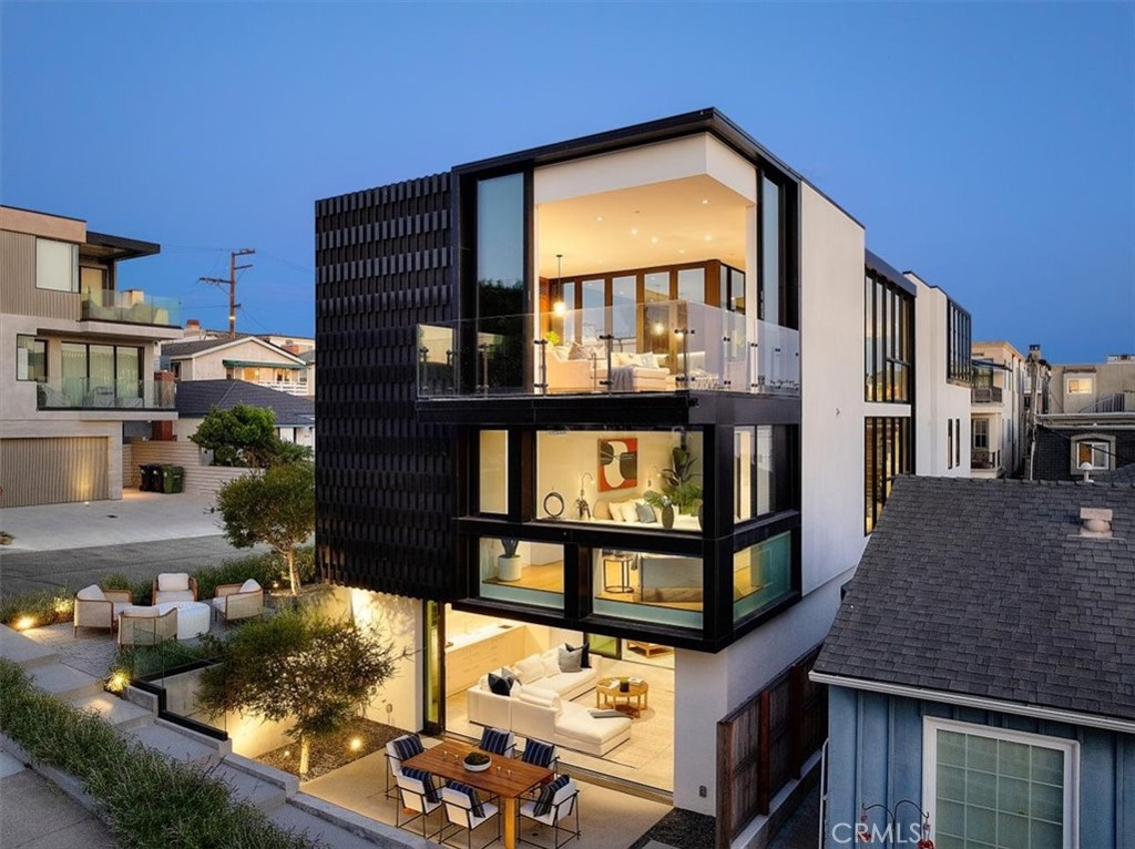 Welcome to “The Switch House” at 2821 Alma Avenue—an architecturally significant modern residence located on a serene walk street just moments from the beach. Designed by renowned firm Brooks + Scarpa and built by PD Construction in 2021, this innovative 5-bedroom, 6-bath home spans approximately 4,000 square feet and takes a unique inside-out approach to beach living.
Rather than clustering open-air spaces along the exterior, this home centers around a stunning multi-use glass courtyard that anchors all three levels, bringing robust natural light and fresh coastal air deep into the interior. Large sliding glass panels and operable windows maximize indoor-outdoor flow while offering views of Palos Verdes, Malibu, and the Pacific.
On the upper level, a sunlit kitchen and family room connect via a skybridge hallway to the living room. This open-air passage—flanked by ocean views—links three separate outdoor balconies that create dynamic spaces for entertaining, dining, and relaxing. With sleek, corner windows that disappear, these areas flow seamlessly into the living space, offering flexibility and privacy all at once.
The home’s thoughtful floorplan includes living spaces on the top and bottom levels, while four of the five bedrooms are privately situated on the middle floor. A glassed-in elevator connects all levels, providing both ease and elegance. Sculpted aluminum screen walls on the façade provide privacy from the walk street while also catching and reflecting sunlight throughout the day, casting beautiful shadows indoors.
Inspired by the homeowner’s upbringing in the lush rainforest above Oahu’s Manoa Valley, the home emphasizes natural ventilation, passive cooling, and a connection to the outdoors. Whether hosting a party that spills onto multiple balconies or relaxing in the inner courtyard under the stars, the home is a true sanctuary.
Designed to harmonize with nature and community, The Switch House is a rare modern masterpiece just moments from the sand.