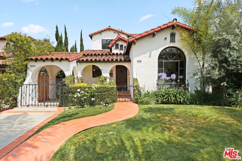 Stunning remodeled Spanish Colonial Revival with ADU north of Beverlywood. Welcome to this idyllic and newly renovated two-story home, where you'll find character & charm along with all the modern comforts. This is not a cookie cutter flip! Carefully chosen custom finishes throughout makes the new feel just as special as the old. With 4 bedrooms and 3 bathrooms in the main house and a 1 bedroom, 1 bathroom ADU, this home has beautifully preserved period details, including arched passageways, exposed wood beams, and a Batchelder tile fireplace, all flooded with wonderful natural light. The kitchen is a cook's dream, with custom cabinetry, high-end appliances, and expansive counter space for cooking and serving. At the rear of the ground level, you'll find a large additional lounging space which opens to the rear yard, perfect for watching movies or entertaining guests. There's also a gorgeous central bathroom and a guest bedroom on the first floor. The house has been completely redone. Ascend the captivating custom tiled staircase to a newly added second level that includes a decadent primary suite with gorgeous period-inspired bath and large walk-in closet. 2 additional bedrooms and a bathroom complete the upstairs. Each room has a generous closet and wonderful views, giving everyone enough space, privacy and quiet. The entire house has warm white oak hardwood floors, new Marvin windows, smart lighting, CAT-7 wiring and 4K security cameras. Walk across the pretty tile patio to the newly built ADU this detached 1 bedroom unit complete with kitchenette and bathroom is super stylish and perfect for guests, home office, or rental income. The inviting backyard provides wonderful entertaining space and easy access to the kitchen for outdoor dining. Ideally situated on a quiet, tree-lined street in Pico-Robertson/Beverlywood Adjacent neighborhood, and within the Canfield Elementary attendance zone, this home is close to Pico Blvd, Beverly Hills, Century City, Culver City and offers much to love!