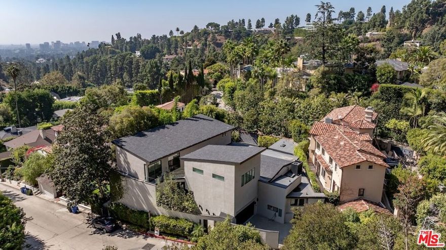Set in the prestigious Beverly Hills Post Office, this property presents a rare chance to reimagine a once-stunning contemporary retreat. This 5-bed, 6-bath residence offers over 4,000 square feet of potential on a private hillside lot with tree-top and canyon views. While the home currently requires significant TLC - including repairs for water damage, mold remediation, and unpermitted work completed by a prior owner, it provides an exceptional canvas for investors, builders, or visionary buyers seeking a project in a premier location. The existing layout includes open-concept living spaces with soaring ceilings, a sleek modern kitchen footprint, and walls of glass opening to the pool and gym or recreation area. The separate upstairs primary suite offers privacy and dramatic light, with a lounge, wet bar, and expansive bath ready for restoration. Outside, the gated driveway and tranquil setting evoke the promise of a serene modern compound once revitalized. Whether you're looking to renovate, rebuild, or restore its architectural essence, 1531 Lindacrest Drive offers unmatched potential in one of Los Angeles' most coveted neighborhoods. Sold As Is - No Repairs or Credits. Reference Docs folder for additional info. Excluded items include: appliances, furniture and fixtures.
