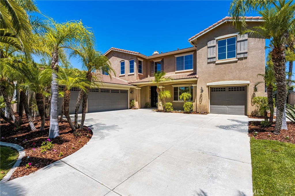 Welcome to Chase Ranch—one of South Corona’s most sought-after neighborhoods. Set on nearly half an acre, this designer-upgraded pool home is a private paradise offering 6 bedrooms, 4 baths, a bonus room, and nearly 3,900 SqFt of stylish living. With panoramic views, rare 4-car garage, and a resort-style yard, this home captures the California dream. Step through the dramatic double-door entry into a soaring two-story foyer with custom wood flooring, elegant lighting, and dramatic wrought-iron detail. The formal dining room connects to a butler’s pantry and flows into an expansive great room with a stacked-stone fireplace, built-in media wall, and walls of windows framing the backyard oasis. The chef’s kitchen is a showstopper—featuring honed porcelain countertops, two-tone cabinetry, farmhouse sink, floating shelves, and premium appliances including double ovens and a 5-burner cooktop with artisan vent hood. A walk-in pantry and oversized island with bar seating and stylish brass pendants finish the space—perfectly positioned to take in the breathtaking views. Just off the great room, a versatile bonus room and full guest suite with stylishly updated bath offer flexibility for guests or multigenerational living. Upstairs, offers 4 bedrooms, including a luxurious primary suite with serene hill views, spa-inspired bath & fully customized walk-in closet. Generous secondary bedrooms accommodate king-size beds, while a spacious laundry room enhances functionality. A dedicated office or optional 6th bedroom completes the upper level. Outside, soak in sweeping vistas as you entertain or unwind in your private oasis—complete with a sparkling pool, elevated spa, pergola-covered firepit, inviting patio, lush lawn, and vibrant tropical landscaping. You’re just minutes from multiple community parks, the Skyline trail, local gems like the Corona Heritage Park & Museum, the Eagle Glenn golf course & clubhouse, and trendy shopping and dining options at The Shops at Dos Lagos or Crossings at Corona with convenient access to the 15 freeway — all tucked into the scenic hills of South Corona. Don’t miss this rare opportunity—schedule your private tour today!