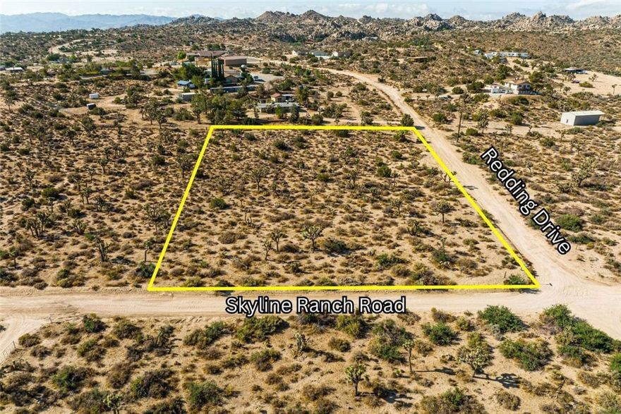 A rare opportunity to acquire your own piece of Southern California desert's iconic landscape. 
APN 0596-03-201, on the corner of Skyline Ranch Road and Redding Drive, offers a 2-acre canvas for the discerning individual. This is not a flat, barren lot; it’s a property with stunning character, featuring a unique terrain, rolling hills, and a treasured collection of Western Joshua Trees. Zoned for equestrian use, this land is ideal for a sophisticated desert compound or a minimalist retreat that honors its surroundings. This spacious lot comes with sweeping views of large areas of undisturbed conservation land that will remain unblemished for generations to come.

With no HOA, your architectural vision is unbound. Design a home that commands attention or one that disappears into the landscape. Utilities are located along the road for your convenience.

Located just minutes from the renowned Joshua Tree National Park and the legendary Pappy & Harriet's Pioneertown Palace, this property offers the perfect balance of seclusion and access. It’s a world away from the hustle and bustle, yet close enough to the creature comforts a city provides.

This is your chance to create a personal sanctuary or a one-of-a-kind short term rental in one of the most sought-after desert communities in the Joshua Tree area. An investment in lifestyle, designed for those who appreciate the exquisite!

Additional Opportunities: Two adjacent lots are also available (2.20 and 2.60 acres), both located on the same road. These side-by-side properties offer the potential to create a truly expansive desert estate. Multi-lot discount available when purchasing two or more parcels together. We happily provide all known information on these unique properties to assist in your discovery process. However, all interested parties should perform their own due diligence to personally verify all details and confirm the land aligns with their vision. Demarcation lines shown in photos are approximated.