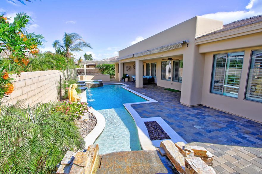 Desert lifestyle living at it's absolute BEST...Located behind the prestigious gated community of Renaissance awaits a fully custom property with upgrades in excess of $125k by the sellers. Features include an open floor plan, recessed lighting, a gourmet chef's kitchen w/high end SS appliances, quartz counter tops, island, walk-in pantry, dual sided wine fridge, plantation shutters and newly installed travertine flooring throughout. Master suite w/large walk-in closet, dual sinks, soaking tub and walk-in shower. A custom seven seat movie theater with 125 inch movie screen complete with surround sound awaits the new owners. The fourth bedroom is currently being used as a home office that can be converted back if needed. Outdoor's you'll find no expense spared on the remodeled salt water pool/spa w/water features, custom pavers throughout, TWO custom high end built-in BBQ's and firepit - perfect for entertaining family and friends. This property will not disappoint the most discerning buyer looking for only the best in luxury living inside and out.