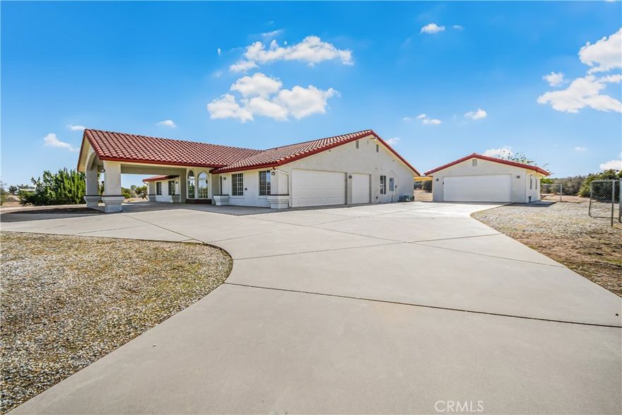 Freshly painted inside and out, this stunning move-in-ready estate immediately impresses with its beautiful circular driveway and porte-cochère, offering covered parking and room for a large number of cars. Step inside to find new carpet throughout the living room, bedrooms, den, and media room, paired with updated light and plumbing fixtures for a modern finish. The kitchen is a true showpiece, featuring a massive breakfast bar, brand new stainless steel appliances, a convenient desk area, and abundant cabinet and countertop space—perfect for both everyday use and entertaining. The home offers a sunken living room, a spacious family room that serves as a great room, a formal dining area, and a breakfast nook, all enhanced by central heat and air for year-round comfort. The master suite includes a massive walk-in closet and a private retreat feel. Additional highlights include an interior laundry room, a dedicated office or den, and a media room ideal for movie nights. Outside, the fully fenced 4.3-acre lot is entirely flat and usable, featuring an attached three-car garage plus an oversized detached two-car garage—ideal for vehicles, storage, or a workshop. The expansive grounds provide ample space for recreation, future projects, or RV parking. Located in an excellent area close to schools, shopping, and amenities, this rare offering combines privacy, space, and modern upgrades. Come see this incredible property today and experience all it has to offer.