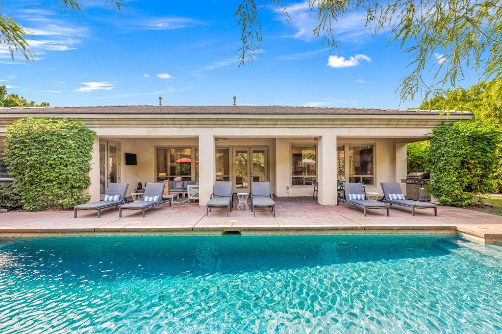 Welcome to your desert retreat in the short-term rental friendly gated community of Montage at Santa Rosa. This gorgeous 3,308 sq ft home features five bedrooms and three and a half bathrooms, providing the perfect blend of luxury and comfort for families and guests alike. Sold turnkey furnished, this property boasts an inviting open floor plan, ideal for entertaining friends and family. The spacious gourmet kitchen is a chef's dream, complete with stunning granite countertops, a large island for meal prep, and elegant travertine floors that enhance the aesthetic. Step outside to discover your own resort-style backyard, designed for both fun and relaxation. You'll find plenty of space for outdoor games, a sparkling pool and spa and a large, covered patio ideal for outdoor dining or lounging by the pool and watching your favorite show. The three-car garage offers ample storage space or the potential for an additional games room. This home is a must-see for anyone looking for a short-term rental investment or a personal desert getaway. Don't miss the opportunity to make this exquisite property yours!