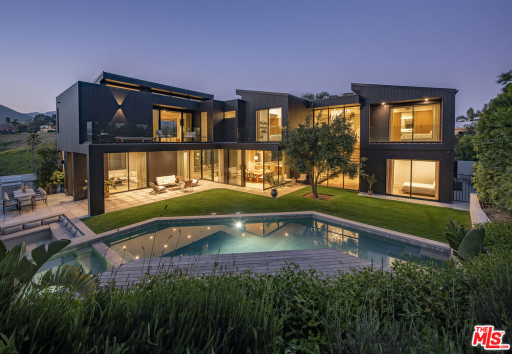 Unbeatable opportunity to own a brand-new modern home in Point Dume, complete with a coveted private beach key! Don't miss your chance to join one of Malibu's most desirable communities with exclusive access to Little Dume Beach. Built in 2022, this stunning contemporary estate offers a beautifully designed four-bedroom, four-bathroom main house, plus a separate one-bedroom guest apartment. Thoughtfully crafted with impeccable style and high-end finishes, the home seamlessly blends indoor and outdoor living, creating an ideal setting for both relaxation and entertaining. Step inside to be greeted by a sun-drenched foyer, soaring floor-to-ceiling windows, and elegant white oak floors. The open-concept layout flows effortlessly, connecting the chef's kitchen, spacious dining area, and dramatic double-height living room centered around a sleek gas fireplace. The kitchen is a dream for culinary enthusiasts, outfitted with top-of-the-line Thermador appliances, a wood-paneled automatic double-door refrigerator, a wine fridge, modern Pitt burners, and ample prep space for hosting. Outside, a private oasis awaits. Lounge by the sparkling pool, soak in the spa tub, or unwind on the LPE wood pool deck. Gather with friends around the sunken seating area and outdoor fireplace, or enjoy al fresco dining at the built-in grill and stone dining table. The first floor includes a stylish guest suite with an en-suite bath and direct access to the yard and pool. Upstairs, two additional guest bedrooms, each with a private bathroom and patio, share a cozy family room with a built-in study area boasting breathtaking mountain views. The upstairs patio and deck offer even more opportunities to take in stunning ocean vistas. The primary suite occupies its own private wing, featuring a spa-like bathroom with a soaking tub, steam shower, and dual sinks. A gas fireplace adds warmth to the space, while a spacious private deck overlooks the pool with glimpses of the ocean and coastline. For added flexibility, the detached guest apartment includes a living area, kitchenette, bathroom, and a loft-style bedroom, perfect for visiting guests or extended stays. A two-car garage and a generous motor court complete this incredible estate, offering ample parking and convenience. This is more than just a home, it's the ultimate expression of the Malibu lifestyle. Don't miss out on this rare chance to own a piece of paradise!