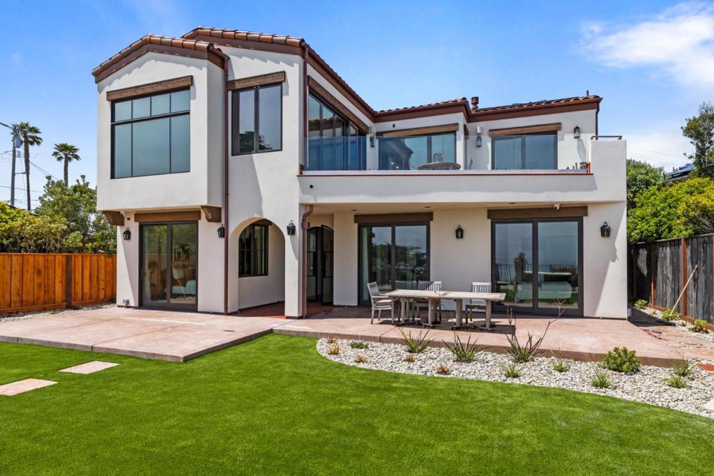 NEW BUILD IN HIGHLY SOUGHT AFTER OPAL CLIFF DR LOCATION, OPTIMALLY SITUATED AT THE 100 YEAR BLUFF SETBACK (50+FEET FROM THE BLUFFS EDGE). INFLUENCED BY THE OCEAN VILLAS OFF THE COAST OF SPAIN, THIS 3373 SQUARE FT OCEANFRONT ANDALUSIA. THE MOMENT YOU ENTER, YOU WILL BE INSPIRED BY THE VIEWS AND THE TASTEFUL USE OF NATURAL MATERIALS. FORGED IRON FIXTURES, NATURAL STONE, HANDMADE SALTILLO TILE, MESQUITE, ALDER, AND WORMWOOD ARE SEEN THROUGHOUT. THIS HOME FEATURES FOUR EN-SUITE OCEAN VIEW BEDROOMS, 2 HALF BATHS, AN ELEVATOR, OFFICE, AND UTILITIES ON BOTH FLOORS. THE KITCHEN IS APPOINTED WITH THE FINEST OF AMENITIES AND ANCHORED BY A STUNNING IJEN BLUE STONE ISLAND. WARMTH RADIATES FROM THE CUSTOM CABINETRY COMPLIMENTED BY HARDWOOD FLOORS AND VAULTED BEAM CEILINGS. A CUSTOM BUILT BEVERAGE CENTER FEATURES ROLL OUT LIGHTED DRAWERS, A MIELE WINE COOLER AND A PERLICK BEVERAGE REFRIGERATOR. THE PRIMARY SUITE OFFERS FULL OCEAN VIEWS AND VAULTED BEAM CEILINGS AS WELL AS A FIREPLACE. SLIDING DOORS ACCESS THE UPPER DECK. EASY ACCESS FROM BOTH LEVELS TO OCEAN VIEWS, SURFERS AT SHARKS COVE, AND GLIMPSES OF SEALIFE. RELAX IN THE SPA, COMMUNE AROUND THE FIRE PIT OR JUST BASK IN THE WARM SUN ON THE PATIO OR DECK. TRULY ONE OF THE FINEST CUSTOM HOMES ON OPAL CLIFF EVER OFFERED.