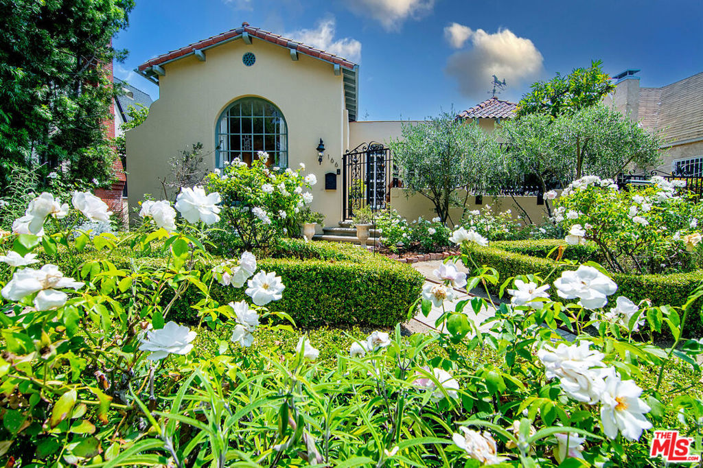 Character 1926 Sunshine Drenched Spanish with 3 beds, 3 baths and a magical backyard! Charming curb appeal with rose garden, winding walkway, gated front porch, automatic driveway gate. Front porch is an outdoor den shaded by an avocado tree that bears fruit! Living room with tall arched windows, newer marble wood burning gas fireplace (operated with key), original wedding cake molding on the high barrel ceiling. Large dining room with high character ceiling and ornate molding + tall arched windows to front porch. Kitchen with new quartz countertops + farmhouse sink + new appliances + bay window opens on one side to a generous breakfast room surrounded by windows, and on the other side a laundry room with door to yard. 3 beds + 3 baths (one en-suite bed is currently staged as an office). Coat closet + linen closet in hallway. Large remodeled bathroom off the hallway has separate shower and tub, vanity with double sinks, large skylight, bespoke design. Primary bedroom is en-suite, with a shower bath + walk-in closet + vanity area, and has French doors to the yard. Gated and uber private backyard is magical with vine covered pergola, water feature, high quality artificial grass, mature trees. Garage and parking in front of the garage with generous driveway and easy safe remote access. Hardwood floors (newer floors in living + dining + hallways), newer central HVAC, upgraded electrical panel, multiple skylights, mostly new windows (all except large arched living room window + 1 bed + 1 bath), Third St School District!
