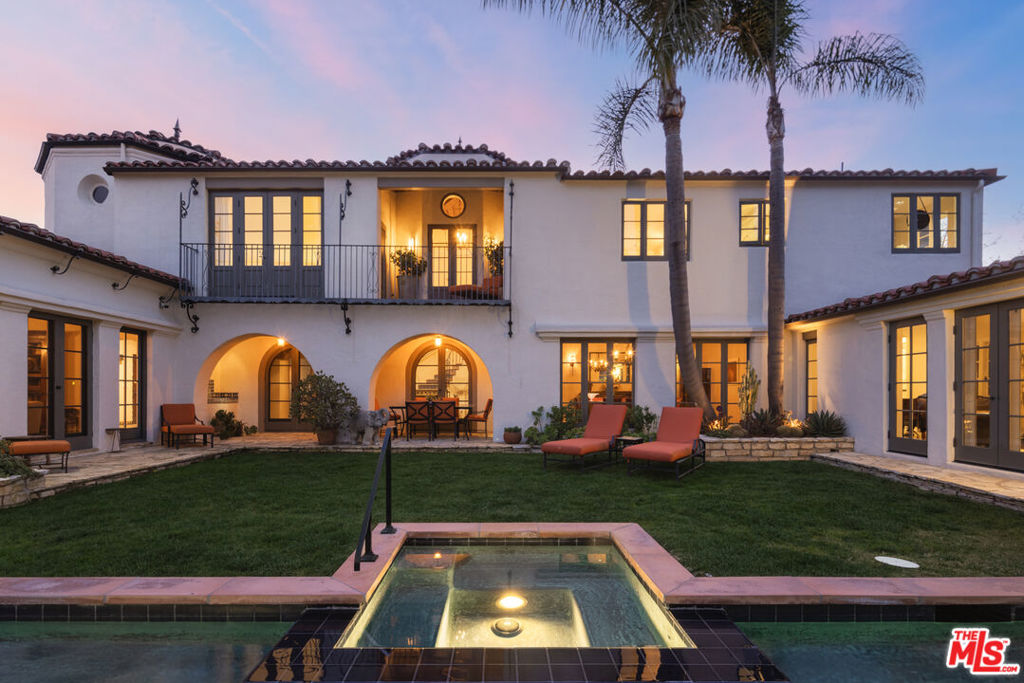 A true architectural gem located on one of the best lots in Little Holmby. Designed by architect Percy Parke Lewis in 1932, this Spanish Colonial Revival is a masterwork of authentic architecture, lovingly and carefully restored. While preserving every stunning detail, this home has been carefully and subtly modernized for today's family living, ready to move in, incorporating a graceful layout including a wonderful chef's kitchen opening seamlessly to the family room, generous bathrooms, spacious closets, and everything needed for today's modern and comfortable living. Irreplaceable stenciled hand carved woodwork, ironwork details, and mahogany paneled library with wet bar have all been fully enhanced and restored to elevate this very special property to a work of art. The primary bedroom suite is a dream retreat with spa-like bath and room-sized dual closets. Situated on a unique promontory lot a stone's throw from Holmby Park, this is one of the rare sites in Little Holmby with views of snowcapped mountains and the city skyline, the flat lot encompasses nearly 11,000 square feet of land with gorgeous mature landscaping, creating a setting that feels a world away in one of the city's most desirable locations.