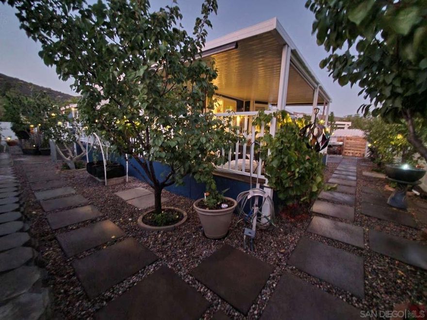 This 55+ HOA community offers homeowners the opportunity of landownership, whereby owners become a HOA shareholder. THERE ARE NO LAND FEES HERE. This is the perfect location for those 55+ who are still working, retired, semi-retired or perhaps just looking for a second, “snowbird” residence. This quality-built, SILVERCREST MODULAR home is entirely TURN-KEY because the furnishings and large appliances convey at no value. Yes, you read that right. They ARE included. So, bring your clothes and a toothbrush and start living the good life. The home's recent updates were purposefully selected to create a vibrant living space meant to evoke a joyful, welcoming environment. The backcountry community of Warner Springs in San Diego County is one of the best kept secrets and MOST AFFORDABLE LOCATIONS anywhere in California. One can live easy knowing that relaxation can be found sitting on the wrap-around deck where the tranquility and wide-open, panoramic views of the mountains and valley is just as easy as throwing open the double French doors and take a deep breath, Congratulations. You're HOME. For the food enthusiast, this kitchen might just check all the boxes in terms of natural light, vaulted ceilings, gas cooktop, pot-filler, abundant storage with pull-out shelving, a chef’s stainless steel island prep table with more storage underneath, a deep single-basin, stainless steel farm sink, under cabinet lights with motion detection for those midnight refrigerator marauding, and the sweetest breakfast area to enjoy your morning coffee that overlooks the landscaped backyard.