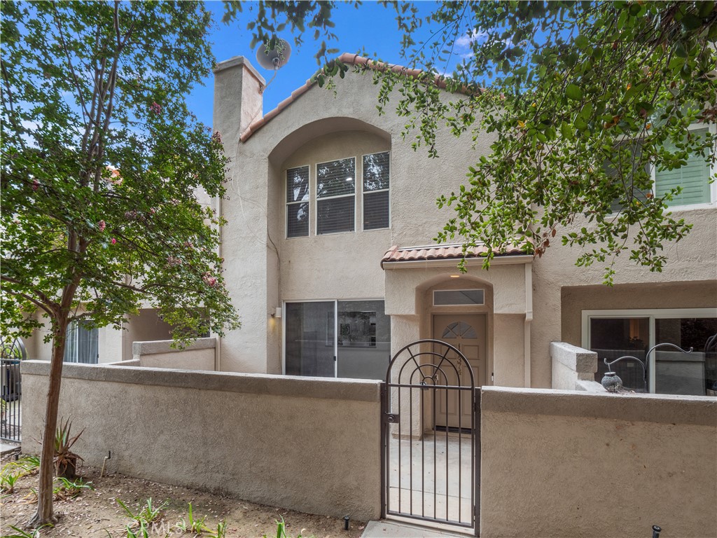 Welcome to 11374 Old Ranch Circle, a stunning home located in the highly desirable community of California West. Tucked away on a peaceful cul-de-sac, this beautifully updated home offers the perfect balance of elegance, functionality, and California indoor-outdoor living. Featuring 2 bedrooms, 3 bathrooms, and 1,427 square feet of living space, this home is ideal for both comfortable living and sophisticated entertaining. Step inside to find a dramatic entry with soaring ceilings and an abundance of natural light that pours through oversized windows. The formal living room is anchored by a fireplace creating a welcoming space for gatherings, and sliding glass doors that lead to the outdoor patio surrounded by lush trees and greenery. The chef’s kitchen is a true highlight, complete with custom cabinetry, Quartz countertops and stainless steel appliances. The main level also offers a 1/2 bathroom. Upstairs, the luxurious primary suite serves as a private retreat, featuring vaulted ceilings, dual walk-in closets, and a spa-inspired en-suite with dual vanities, and a separate glass-enclosed shower. The secondary master bedroom is spacious and bright, with a walk-in closet and is complemented by its own updated bathroom. Additional highlights include an attached 2-car garage with direct access, an in-unit laundry, central heating and air conditioning, and elegant upgrades throughout including engineered wood flooring and recessed lighting. The community offers its residents 2 separate sparkling pool and spa areas, each with large grassy areas to enjoy. Mature landscaping surrounds the community with privacy and a serene atmosphere. Located within a secure community, this property offers the tranquility of suburban living with convenient access to top-rated schools, scenic hiking trails, shopping, dining, and the 118 freeway for easy commuting. Welcome to your Next Home!