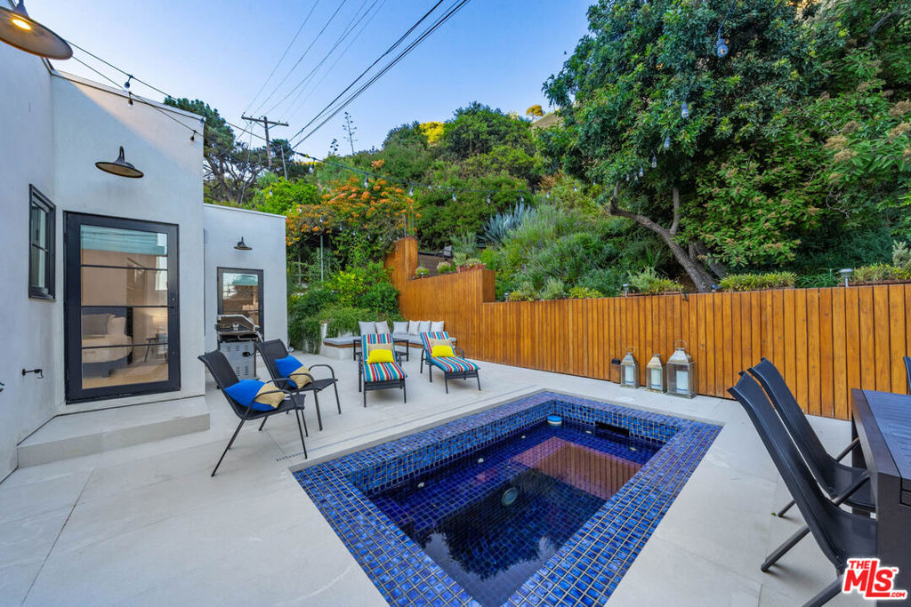 Introducing a Hollywood Hills GemNestled in the heart of the Hollywood Hills and surrounded by coveted hiking trails, this completely remodeled, never-lived-in single-story residence offers the perfect blend of modern luxury and serene privacyjust minutes from West Hollywood.Featuring 3 bedrooms plus a bonus basement suite with its own private kitchen and bathroom, and 3.5 baths, the home is designed for both comfort and versatility. The spacious living room welcomes you with vaulted ceilings and a cozy fireplace, while the chef's kitchen with Viking appliances opens seamlessly to the dining room, breakfast nook, den, and a striking powder room.Throughout the home, wide-plank oak flooring creates warmth and sophistication. Smart home features include integrated lighting controls, a Ring alarm system with security cameras, built-in sound, and TVs in every room. A dedicated laundry room with washer and dryer adds convenience.Step outside to your private backyard oasis, complete with a large jacuzzi pool, herb garden, and lush greenery. The property also includes a two-car garage with additional storage.This is more than a homeit's your Hollywood Hills sanctuary, move-in ready and waiting to be enjoyed.