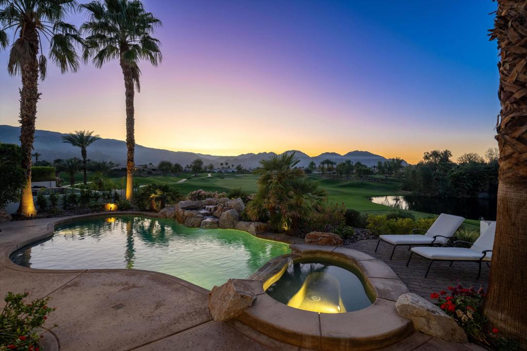 Enjoy all that Andalusia at Coral Mountain has to offer in this fabulous golf course home, perfectly situated on an elevated lot above the 8th fairway of the Rees Jones-designed course. Boasting breathtaking views of three fairways, a serene lake, and the majestic Santa Rosa and Coral Mountains, this residence offers a dramatic lifestyle with all the essentials for entertaining. The spacious open floor plan is offered furnished and features two expansive primary suites, each with luxurious, spa-like baths for ultimate relaxation. Guests will feel right at home in the detached two-room casita, complete with a cozy fireplace, private bedroom and bath, and a kitchen bar with a refrigerator and microwave. The great room is beautifully finished with custom built-ins, travertine flooring, shutters, electric solar shades, volume ceilings, and expansive glass doors that open to an incredible covered outdoor living area. The chef's kitchen features a large center island, premium appliances, and a butler's pantry. Step outside to your own private backyard paradise, where a sparkling pool and spa take center stage, complemented by a built-in BBQ island--all framed by unrivaled golf course and mountain views. Come live the life you've always imagined!