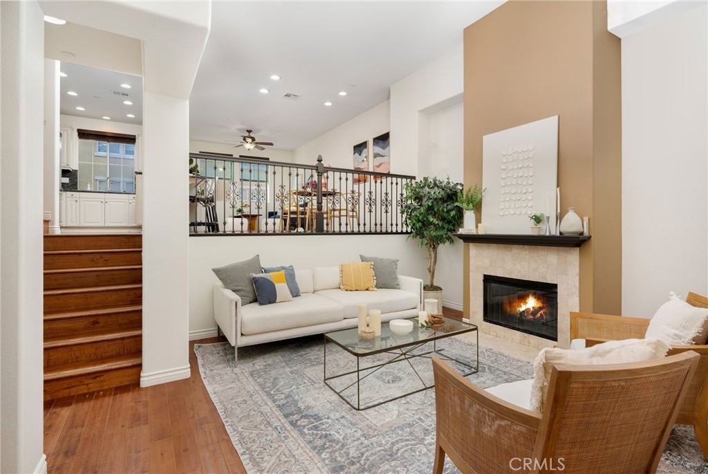 Tucked within the gated Tremont enclave of Serrano Heights, this beautiful townhouse blends modern comfort with everyday elegance. From the moment you step inside, you’re greeted by an airy formal living room with dramatic vaulted ceilings, a warm gas fireplace, engineered hardwood flooring, and sun-drenched windows that instantly make the space feel inviting. Continue into the heart of the home — a thoughtfully designed kitchen with granite countertops, stainless steel appliances, and a central island perfect for morning coffee or gathering with friends. The open layout flows effortlessly into a dining area ideal for dinner parties or family meals, creating the perfect balance between formality and ease. Upstairs, discover three spacious bedrooms and two and a half baths, including a serene primary suite complete with a spa-inspired ensuite bathroom, floating dual vanity with quartz countertops, a walk-in shower, and an expansive closet designed for organization and style. The laundry room is conveniently located on the same level, featuring built-in cabinetry for added everyday function. Two other bedrooms are located on the same floor. With direct-access two-car garage with extra storage, and thoughtful upgrades throughout, this home checks every box. The Tremont community offers manicured greenbelts, lush landscaping, and proximity to scenic Santiago Oaks and Fred Barrera Regional Parks, where miles of trails and natural beauty are just steps away. Residents here enjoy the comfort of a close-knit, well-maintained neighborhood—just a short walk to one of Orange County’s top-rated elementary schools. Offering sophistication, convenience, and connection all in one, this home isn’t just a place to live—it’s a lifestyle to be proud of!