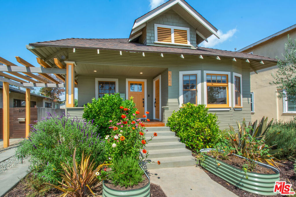 Welcome to 2347 West 29th Place, a masterfully renovated Craftsman home situated in the esteemed Jefferson Park Historic Preservation Overlay Zone (HPOZ). This stunning residence harmonizes modern amenities with the charm of its 1908 origins, offering a unique living experience in a vibrant, culturally rich community. This exquisite residence features three gorgeous bedrooms and two impeccably updated bathrooms. The primary suite provides direct access to the backyard, perfect for enjoying peaceful mornings and vibrant sunsets. The modern kitchen, with massive storage, is designed for both functionality and style. Every detail of this home has been thoughtfully crafted including the stunning wide plank hardwood floors throughout. Newer systems including windows, electrical, plumbing, and HVAC, ensuring both comfort and efficiency. A standout feature of this property is the finished oversized garage, offering endless possibilities for extending your living space. Whether you envision a home office, studio, ADU or entertainment area, this versatile space adapts to your needs. Set on an expansive 5,380 square foot lot, the outdoor space is ideal for relaxation and gatherings. A long driveway and detached garage offer ample parking solutions. Embrace the unique blend of history and modernity in Jefferson Park, a neighborhood celebrated for its architectural beauty and diverse community spirit. For more information on the district and its preservation, visit Jefferson Park HPOZ. Discover a lifestyle where historic charm and present harmoniously coexist.