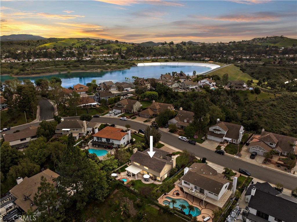 Enjoy peaceful privacy in this traditional Hunter's Pointe 5-bd home located on a premiere VIEW lot near the top of the neighborhood. From the grand two-story entry at the front to the walls of windows lining the backyard, this light-filled home beckons instant relaxation and a welcoming feel to everyone who visits. An oversized 10,680 sqft park-like backyard features a large grass lawn, mature privacy trees & hedges, custom weather-resistant metal patio trellis, multiple rose bushes, a built-in brick-lined heated spa and serene views of city lights, nearby foothills and distant mountains.
Highlights include: brand new replaced Siemens 200amp electrical panel with warranty, entire new $40,000 reroof with Eagle Lightweight Tile & 1/2-inch radiant barrier OSB sheathing with 20-year pitched roof workmanship warranty & lifetime material warranty, energy-efficient appliances include HVAC system, whole house Milguard dual-pane windows & slider doors and Nest Smart-technology air-conditioning & heating. Hardwood & marble floors, deep baseboards, quartz counters and stainless steel kitchen appliances complete the home. The oversize garage fits 3 cars inside plus 3 additional cars outside on the wide custom paver driveway for a total of 6-car parking. More photos coming soon.