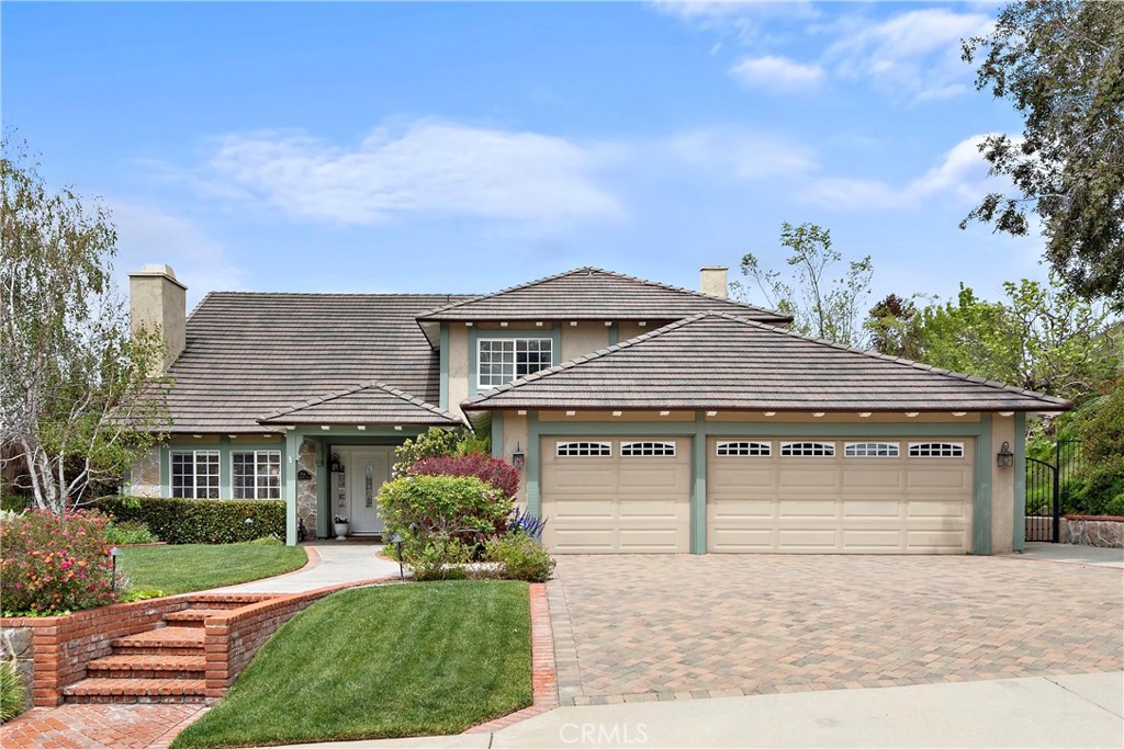 Location, location, location! Situated on just shy of a 1/4 acre quiet VIEW lot in the coveted and rarely available Hunter Pointe neighborhood of Anaheim Hills, 784 Goldfinch Way is a delightful French Country style home that offers five spacious bedrooms, three baths and an expansive 800+ sqft 3-car garage. Delightful curb appeal with an expansive front yard & welcoming landscaping sets this home apart along with its prime location near the crest of the neighborhood's wide streets. Originally built by Warmington Homes and cherished for boasting oversized yards and close proximity to both jogging paths and nearby golf course, this residence features the largest and most popular floorplan, with one bedroom on the main floor and four additional bedrooms upstairs. From the grand two-story front entry to the walls of windows overlooking the backyard, this bright and inviting home immediately offers a sense of relaxation and a warm welcome to every guest.
Significant upgrades include a brand new 200 Amp electrical panel (2024), a new lightweight tile roof with energy-efficient radiant barrier sheathing (2025), Milgard dual-pane windows and sliding doors throughout the house (2013), Nest smart thermostat system for energy savings (2022), American Standard AC/HVAC system (2015), Bosch dishwasher (2023), new water heater (2020), new interior paint (2025), and professional landscaping with irrigation, exterior lighting, a metal patio cover, and a custom paver driveway and entry (2015).
A standout feature of this exceptional property is the oversized, park-like backyard with breathtaking sunset and snow-capped mountain views from the large grassy area. It includes a replastered built-in brick-lined heated spa, mature privacy trees, over 20 rose bushes, a weather-resistant metal patio trellis with an outdoor TV, a fruit-bearing lemon tree, and serene vistas of city lights, surrounding foothills, and distant mountains. Additionally, the 3-car garage plus bump-out and high-beamed ceilings can accommodate three cars inside and three more on the spacious custom paver driveway, totaling six-car parking. Other highlights include hardwood/stone flooring on the main level, two gas fireplaces, quartz countertops with GE Profile stainless steel kitchen appliances, top-rated elementary, middle, and high schools with 90th percentile State Rating, quick access to shopping, dining, and parks; and low association dues of $194 per quarter with no mello-roos.