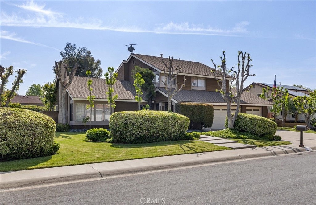 Remarkable value in this 4 bedroom home ~This 2 story home is situated on a flat 12,825 sqft (approximate) private lot near the turn of a cul-de-sac! Double door entry opens to spacious formal living room with vaulted ceilings, fireplace and lots of windows to bring in natural light ~ Formal dining room is spacious enough for large dinner gatherings ~ Light and bright white kitchen features a garden window, gas range, microwave and a spacious casual eating area overlooking the rear yard ~ Oversized separate family room allows for easy furniture arrangement which is a perfect setting for entertaining ~ Circular staircase leads to the primary bedroom which features a cathedral ceiling and private bathroom with dual a dual vanity and soak tub with shower ~ Additional 3 bedrooms are ample in size and share a hall bathroom with a dual sink vanity ~ Convenient inside laundry and ½ bathroom downstairs ~ 3 car garage! Incredible 12,825 sqft.(approximate) lot is an open canvas for an amazing rear yard ~ Ample room for a pool and outdoor living areas ~ THIS IS A HOME OF SPACE AND COMFORT! Nice curb appeal with manicured lawn and garden areas!
