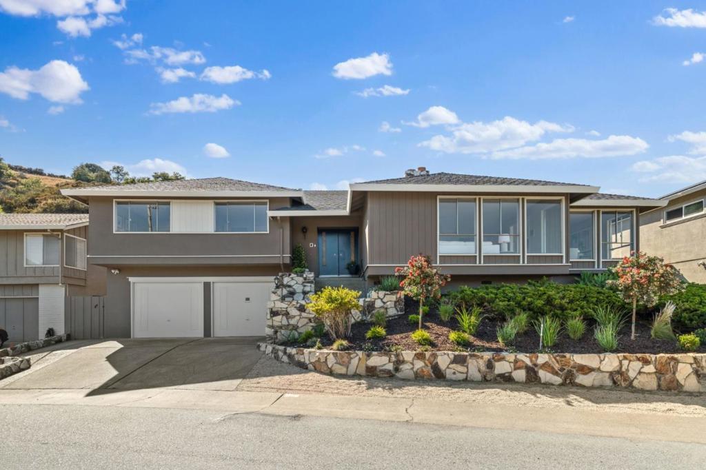 Tucked at the end of a quiet cul-de-sac, 942 Viewridge Drive offers an exceptional blend of timeless design, natural beauty, and refined comfort. Captivating Bay views and direct access to Sugarloaf Mountain Open Space create an unparalleled sense of privacy and serenity. Meticulously maintained by one family since its original construction, the home is thoughtfully designed for both elegant entertaining and everyday ease. Light-filled formal rooms, a generous eat-in kitchen with double ovens, and a spacious family room with fireplace, built-ins, and wet bar provide a graceful flow for living and hosting. Upstairs, a tranquil primary suite overlooks open space and features a walk-in closet and dual-sink vanity. Three additional bedrooms plus a versatile bonus room offer flexibility for guests, office, or retreat. Central A/C, seismic upgrades, oversized garage, and lush outdoor spaces complete the home. Located in the top-rated Belmont-Redwood Shores School District.