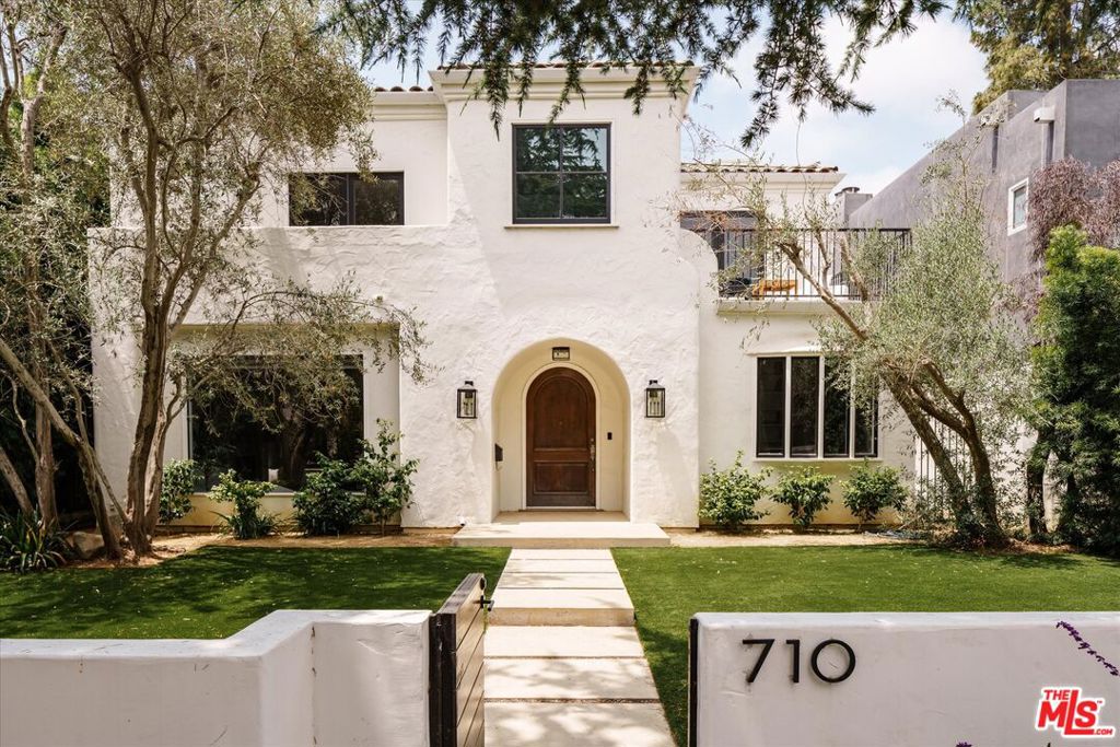 Magnificent contemporary Mediterranean home in a highly sought-after North of Montana location, nestled on a picturesque tree-lined street. Enclosed by verdant, mature landscaping, the property offers a sense of seclusion and tranquility. Upon stepping inside, be welcomed by an abundance of natural light, soaring vaulted ceilings, exquisite pale wood floors, and a well-designed floor plan. The residence boasts an expansive dining room, a cozy den/office, and a formal living room that opens up to a spacious chef's kitchen and breakfast area overlooking a delightful patio. The luxurious primary retreat includes a charming sitting area and a balcony overlooking the tree-lined street. This impressive property also features four additional well-sized bedrooms. Conveniently situated within the highly regarded Franklin school district and a short distance to the Brentwood Country Mart with an abundance of shopping and dining options!