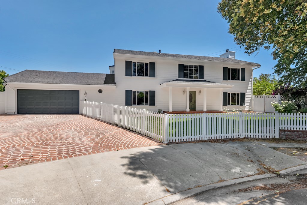 Fully Remodeled Northridge Masterpiece on a Quiet Cul-de-Sac! This beautifully remodeled 4-bedroom, 3-full bathroom home, perfectly situated on a peaceful cul-de-sac in prime Northridge offers the best of everything. Move-in ready and meticulously upgraded throughout, this stylish residence combines modern luxury with everyday comfort. Step inside to find engineered wood floors, new interior and exterior paint, all-new dual pane windows, and a brand-new HVAC system—providing energy efficiency and year-round climate control. The heart of the home is the stunning chef’s kitchen, featuring stainless steel appliances, a large center island with breakfast bar, glass showcase cabinetry, recessed lighting, and an abundance of counter space—ideal for both entertaining and everyday cooking. The open-concept layout flows effortlessly through sun-filled living areas, including a formal dining room, elegant living room with fireplace, and a spacious family room—offering plenty of space to gather, relax, and unwind. The luxurious primary suite offers a peaceful retreat, complete with a walk-in closet and a spa-inspired en-suite bathroom featuring a frameless glass shower and separate soaking tub. Three additional bedrooms provide comfort and versatility, while all bathrooms have been beautifully remodeled with top of the line modern finishes. Convenience is key with an indoor laundry room and a layout designed for both functionality and style. Step outside to your private backyard oasis—an entertainer’s dream with a large covered patio perfect for al fresco dining, lush greenery, and beautifully landscaped grounds. Located minutes from the Porter Ranch Vineyards, CSUN, dining, shopping, Northridge Mall and top-rated schools—this exceptional home offers the perfect blend of location, luxury, and lifestyle.
