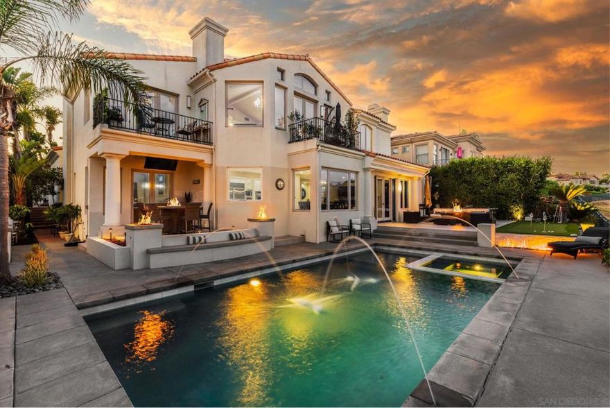 Located in the highly sought out gated community of Aviara Point, this custom-built home offers incredible 180° views of the Aviara Golf Course and surrounding mountains! The home blends comfort, privacy, and functionality in a peaceful and scenic setting. The private backyard is an entertainers dream that includes a pool with electric cover, spa, fire pit, putting green, built-in BBQ, and even an outdoor shower —all surrounded by lush landscaping and open views of the 7th hole. Enjoy California’s indoor/outdoor living at its finest! As you step inside the home, you’re welcomed by a light-filled entry with high ceilings and a sweeping staircase. The open-concept great room features large windows that frame spectacular views, while the gourmet kitchen is fully equipped with stainless steel appliances, double ovens, built-in fridge, and a large center island —ideal for both everyday living and grand entertaining. The layout includes two spacious downstairs suites with private entrances—perfect for guests, multi-generational living, or private maid's quarters. Upstairs, the luxurious primary suite offers a sitting area with fireplace, spa-inspired bath with Jacuzzi tub, large walk-in shower, dual walk-in closets, and beautiful wood french doors opening to a private balcony with endless views. Three additional en-suite bedrooms down the hall ensure comfort and privacy for all.  Additional features include: dual-zone heating and air conditioning, extensive use of travertine and crown molding, an advanced security system, multiple home office spaces, and a spacious three-car garage.  This home offers a rare combination of luxury, privacy, and scenic beauty in one of Carlsbad’s most desirable gated communities!