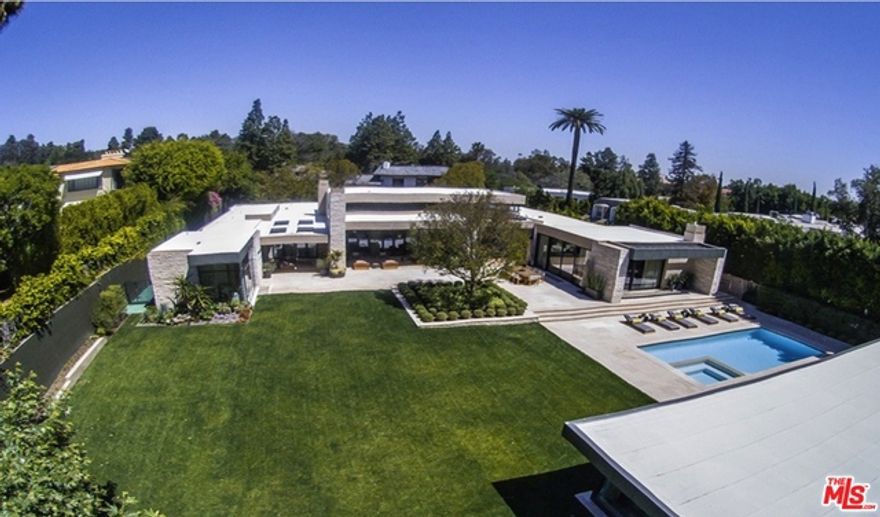Exquisite Warm Modern tucked behind the Beverly Hills Hotel. Approx. 12,000 sq ft on a large flat lot and perched above the street. Grand height entry with voluminous and perfectly scaled public rooms designed for large scale entertaining and sophisticated stylish living in a very private exclusive setting. Formal living, dining and family rooms and oversized open chef's kitchen looking out to the beautiful grounds and pool. Fabulous master quarters with large custom his/her closets, personal salon, baths and fireplace. 3 additional suites upstairs. Private and luxurious wine tasting room and basement cellar. Separate staff entrance with bedroom downstairs. World class and timeless design fitting of the most exclusive location in Beverly Hills.