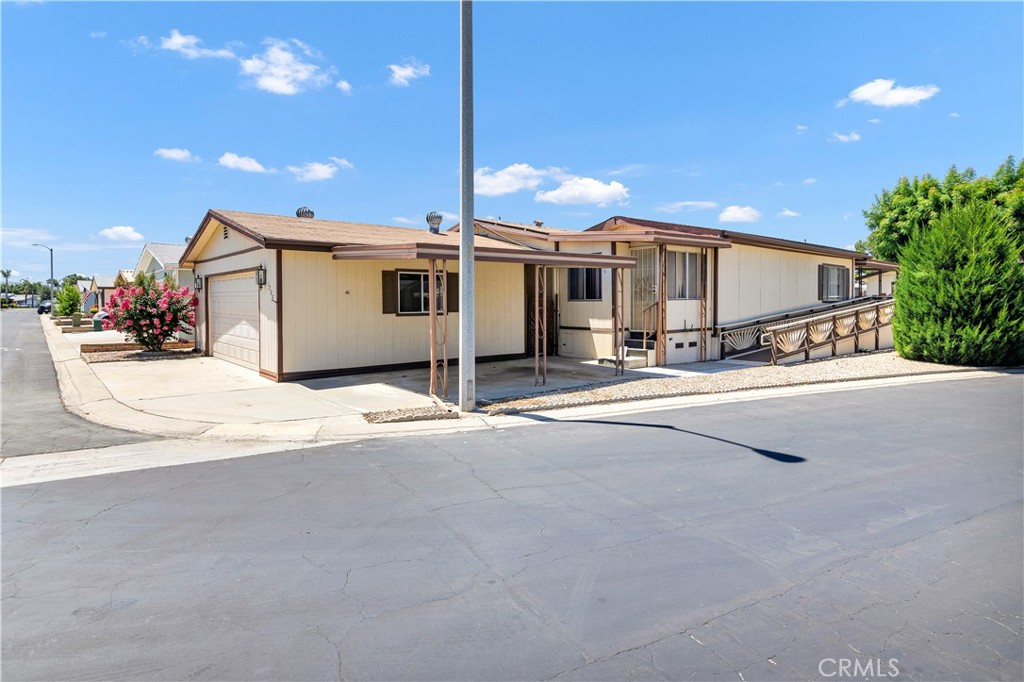 Welcome to the beautiful gated 55+ community of Eastlake where you own the land, Up the Handicapable access ramp, You'll enjoy relaxing on the front porch in a comfortable setting with direct access to the front door and living room. This spacious home features 2 bedrooms, and 2 bathrooms ,The primary bedroom has full walled mirrored closet doors and an additional closet, Off the Primary bedroom is a Craft room/Office, The primary bathroom features dual pullman's, a large soaking tub and a separate shower, The 2nd bedroom has access to the jack and jill guest bathroom that has an EZ Step in shower. The open kitchen will not disappoint, with tons of storage, built-in oven, gas cooktop and breakfast area. This open floorplan has a relaxed atmosphere feeling, The laundry room is large in size with a built-in desk and tons of storage. Next to the 2 car garage is a covered car port, Bring your tool kit and make this your next home, HOA amenities include a large clubhouse, pool, gym, barbecue area, pickleball, tennis courts, water, trash and sewer. Make this one a must see!
