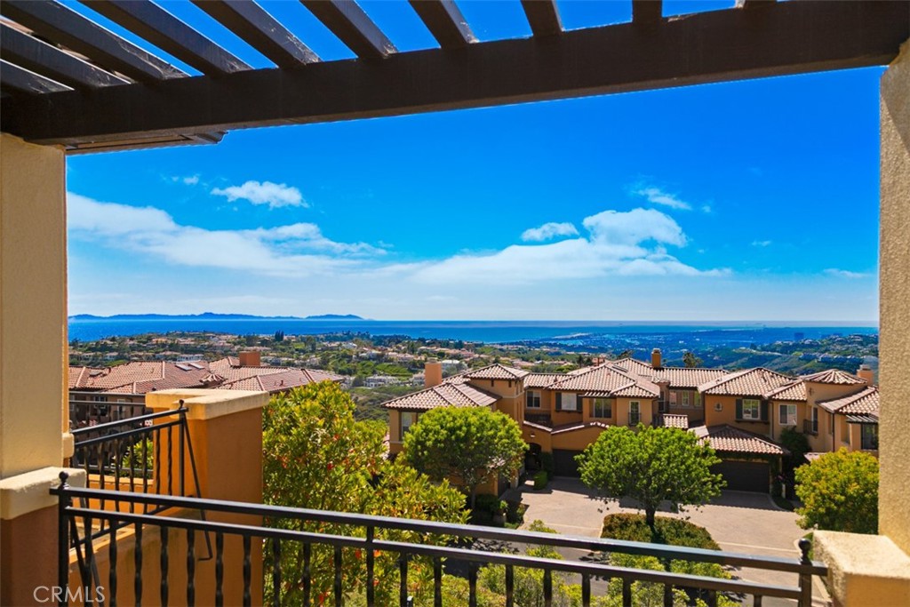 Set within the prestigious gated enclave of Altezza in Newport Coast, this newly renovated residence, completed in 2025, captures sweeping panoramic vistas—spanning the Pacific Ocean, Catalina Island, Newport Harbor, sparkling city lights, and the distant Saddleback Mountains. The home offers a rare blend of elegance, comfort, and coastal sophistication. Upon entering the property, one will notice a highly refined level of detail...often not found at this price point or property level. Nearly every aspect of the property remodel was thought of during its 15 month renovation process. From new floorings, custom millwork and cabinetry, lighting, stone selections, AC Systems and air scrubbers, bathrooms, the garage, and much more, this property is a true example of what a "move in ready" property is suppose to feel like. Upon entering, the property foyer and view greet you simultaneously, effortlessly showcasing the unique property position on the hill. Walking through the entry level, one will notice a main level bedroom with a well appointed bathroom, dining room, kitchen framed by ocean views and a private patio pavilion, open breakfast nook, and large family room with double vaulted ceilings. The family room is further highlighted with a dramatic stone fireplace, well positioned to create a cozy environment for relaxation and rejuvenation. Upstairs, the expansive primary suite is a true retreat, complete with a private balcony showcasing exceptional views, and a spa-style bath featuring dual vanities, a soaking tub, and separate shower. A secondary en-suite bedroom completes the upper level along with a spacious bonus room. The property also showcases a full laundry room and direct access 2 car garage that has been beautifully upgraded with flooring, cabinetry, lighting and a new garage door system. This property also features direct access to the Newport Coast Community Center and Clubhouse, featuring a Junior Olympic saltwater pool, sport courts, and kitchen with lounging areas. Rounding out this property is immediate proximity to scenic trails, top-rated schools, and world-class shopping and dining at Fashion Island, The Newport Coast Shopping Center, and the Pelican Hill Resort.