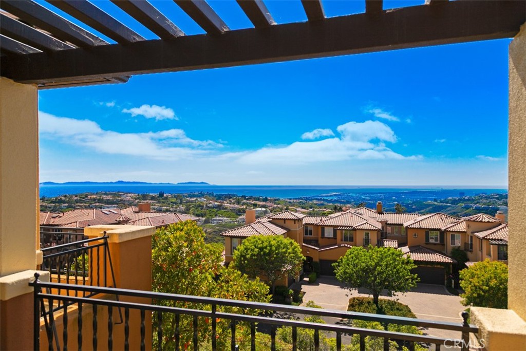Set within the prestigious gated enclave of Altezza in Newport Coast, this newly renovated residence, completed in 2025, captures sweeping panoramic vistas—spanning the Pacific Ocean, Catalina Island, Newport Harbor, sparkling city lights, and the distant Saddleback Mountains. The home offers a rare blend of elegance, comfort, and coastal sophistication. Upon entering the property, one will notice a highly refined level of detail...often not found at this price point or property level. Nearly every aspect of the property remodel was thought of during its 15 month renovation process. From new floorings, custom millwork and cabinetry, lighting, stone selections, AC Systems and air scrubbers, bathrooms, the garage, and much more, this property is a true example of what a "move in ready" property is suppose to feel like. Upon entering, the property foyer and view greet you simultaneously, effortlessly showcasing the unique property position on the hill. Walking through the entry level, one will notice a main level bedroom with a well appointed bathroom, dining room, kitchen framed by ocean views and a private patio pavilion, open breakfast nook, and large family room with double vaulted ceilings. The family room is further highlighted with a dramatic stone fireplace, well positioned to create a cozy environment for relaxation and rejuvenation. Upstairs, the expansive primary suite is a true retreat, complete with a private balcony showcasing exceptional views, and a spa-style bath featuring dual vanities, a soaking tub, and separate shower. A secondary en-suite bedroom completes the upper level along with a spacious bonus room. The property also showcases a full laundry room and direct access 2 car garage that has been beautifully upgraded with flooring, cabinetry, lighting and a new garage door system. This property also features direct access to the Newport Coast Community Center and Clubhouse, featuring a Junior Olympic saltwater pool, sport courts, and kitchen with lounging areas. Rounding out this property is immediate proximity to scenic trails, top-rated schools, and world-class shopping and dining at Fashion Island, The Newport Coast Shopping Center, and the Pelican Hill Resort.