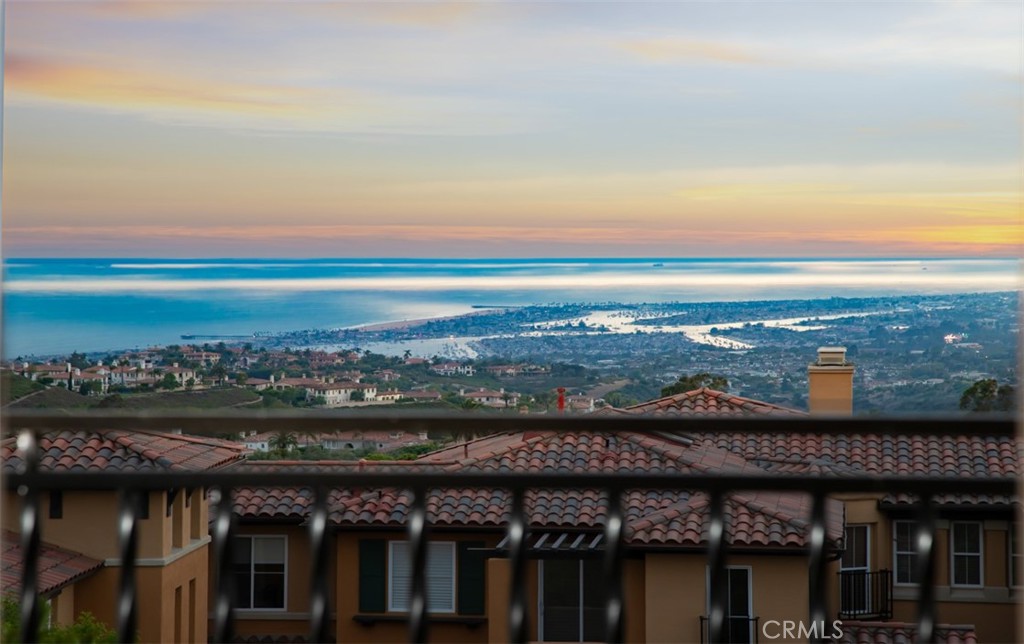 Set within the prestigious gated enclave of Altezza in Newport Coast, this newly renovated residence, completed in 2025, captures sweeping panoramic vistas—spanning the Pacific Ocean, Catalina Island, Newport Harbor, sparkling city lights, and the distant Saddleback Mountains. The home offers a rare blend of elegance, comfort, and coastal sophistication. Upon entering the property, one will notice a highly refined level of detail...often not found at this price point or property level. Nearly every aspect of the property remodel was thought of during its 15 month renovation process. From new floorings, custom millwork and cabinetry, lighting, stone selections, AC Systems and air scrubbers, bathrooms, the garage, and much more, this property is a true example of what a "move in ready" property is suppose to feel like. Upon entering, the property foyer and view greet you simultaneously, effortlessly showcasing the unique property position on the hill. Walking through the entry level, one will notice a main level bedroom with a well appointed bathroom, dining room, kitchen framed by ocean views and a private patio pavilion, open breakfast nook, and large family room with double vaulted ceilings. The family room is further highlighted with a dramatic stone fireplace, well positioned to create a cozy environment for relaxation and rejuvenation. Upstairs, the expansive primary suite is a true retreat, complete with a private balcony showcasing exceptional views, and a spa-style bath featuring dual vanities, a soaking tub, and separate shower. A secondary en-suite bedroom completes the upper level along with a spacious bonus room. The property also showcases a full laundry room and direct access 2 car garage that has been beautifully upgraded with flooring, cabinetry, lighting and a new garage door system. This property also features direct access to the Newport Coast Community Center and Clubhouse, featuring a Junior Olympic saltwater pool, sport courts, and kitchen with lounging areas. Rounding out this property is immediate proximity to scenic trails, top-rated schools, and world-class shopping and dining at Fashion Island, The Newport Coast Shopping Center, and the Pelican Hill Resort.