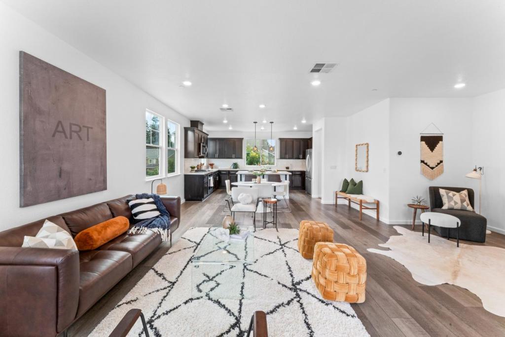 Experience elegant, bright, and spacious living in this stunning 4-bedroom, 3.5-bathroom tri-level townhome. A unique corner unit with an open floor plan of 1,967 sq ft and high ceilings, it provides tons of natural light and unobstructed views, giving you the feel of a single-family home with exceptional privacy. The home is NE facing and was thoughtfully built according to Vastu guidelines. The heart of the home is a contemporary kitchen, a chef's dream with a central island, luxurious countertops, a walk-in pantry, and high-end finishes. A rear bedroom and full bathroom on the first floor offer a versatile space perfect for a home office, a private guest suite, or multi-generational living. This is a true pride of ownership with an impressive array of upgrades including a tankless water heater, whole house water filter, smart light switches, and an EV charger-ready garage. The primary bedroom is a private retreat with large windows, an attached master bath with a spacious shower, and marble floors. Enjoy a private patio perfect for hosting friends and family and a prime location for commuters and outdoor enthusiasts. Just minutes from the BART station and major freeways, this gated community provides an environment with park-like setting and ample guest parking.