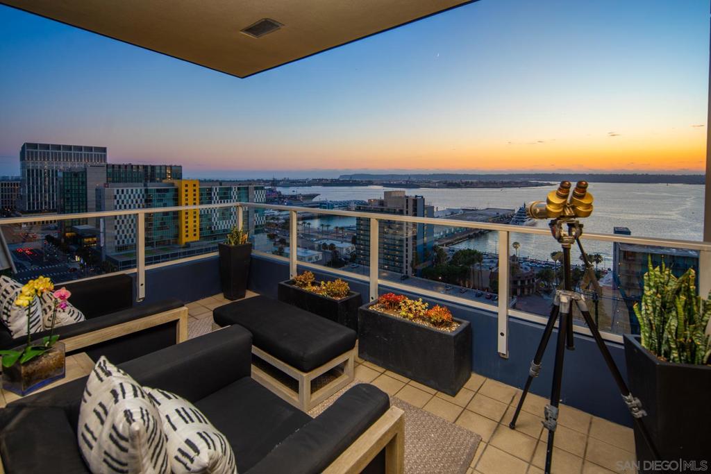 Truly one-of-a-kind, thoroughly upgraded residence in one of San Diego’s premier luxury high-rises—Bayside on Millionaire’s Row. No expense was spared in this extraordinary southwest-facing corner unit, offering sweeping views of the bay, city skyline, and unforgettable sunsets over the Pacific. Meticulously maintained by the original owner, this home underwent a complete down-to-the-studs remodel in 2018 with over $500,000 in ultra-premium upgrades, all designed to maximize the views and floorplan and elevate the living experience to an exceptional level. Step inside through a dramatic formal entry featuring coffered ceilings, custom wood storage and closets fabricated from Koa wood imported from Hawaii, designer lighting, and a full-length wine fridge. The open-concept living, dining, and kitchen areas have been thoughtfully reconfigured to maximize natural light and frame the incredible views from every angle. A private balcony extends the living space, perfect for entertaining or simply soaking in the beauty of San Diego’s waterfront. Custom ceilings with sleek modern lighting, Duchateau flooring, Koa wood accents throughout, and carefully selected quartzite natural stone finishes provide elegance and cohesion throughout. The chef’s kitchen is a showpiece, complete with a coffered ceiling, custom German cabinetry, breakfast seating, Miele appliances, and quartzite natural stone counters. The living and dining rooms feature Koa storage and quartzite natural stone accent walls that highlight the home’s artistry. ...See Supplement... Retreat to the serene primary suite with its own private balcony, custom Koa furnishings, and a larger than original walk-in closet with a California Closet system and custom built-ins. The spa-inspired bath offers dual sinks, a walk-in shower, and striking custom stonework. A flexible floor plan includes a home office and guest bedroom with a custom Zoom bed, while the guest bath offers a freestanding soaking tub and designer finishes. Additional highlights include power blinds throughout (blackout in bedrooms), ample storage, and two side-by-side premium parking spaces with a dedicated electric charger for your Tesla or other electric vehicle, conveniently located just outside the elevator with separate storage. Bayside residents enjoy a newly renovated lobby, 24-hour concierge, pool, spa, sauna, steam room, movie theater, conference room, wine lounge with oversized chiller, BBQ areas, library, and more. Perfectly located, you’re steps from Little Italy, the Gaslamp, Waterfront Park, Petco Park, the Rady Shell, and San Diego’s best dining, shopping, and entertainment. This residence represents the very best in luxury downtown living on the front row to the waterfront.
